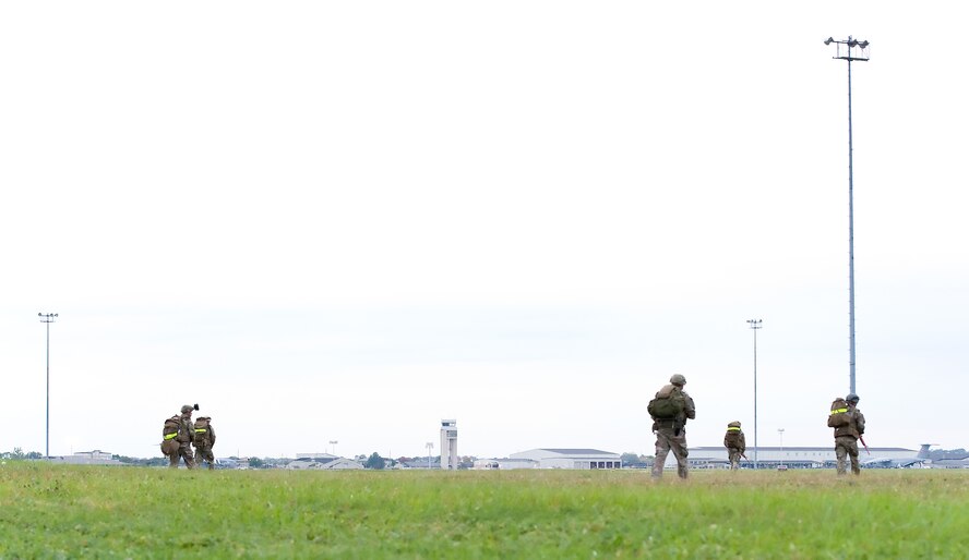 Members of the 436th Civil Engineer Squadron Explosive Ordnance Disposal Flight return to their point of origin on the east side of the base Oct. 10, 2014, on Dover Air Force Base, Del. During a three-mile long soldiering skills training event, EOD flight personnel trained on the east side of the base during the early morning. (U.S. Air Force photo/Roland Balik)