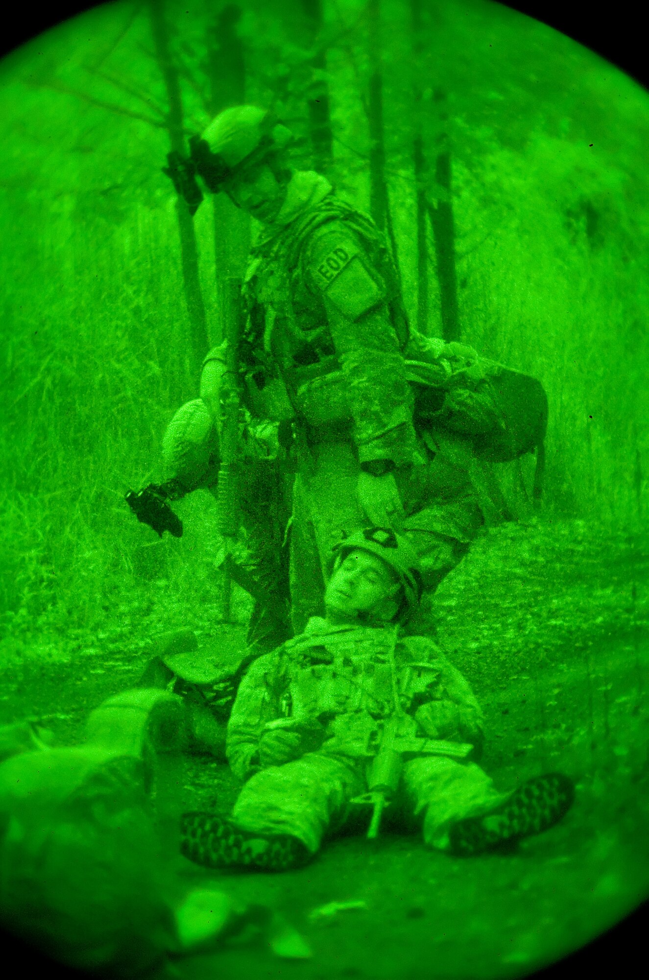 Airman 1st Class Colby Hillman, stands over Airman 1st Class Andrew Vitale, both 436th Civil Engineer Squadron Explosive Ordnance Disposal technicians, after coming under a simulated attack while on patrol Oct. 10, 2014, on Dover Air Force Base, Del. Vitale suffered a simulated gunshot wound and became unconscious requiring immediate simulated delivery to a medical facility. (U.S. Air Force photo/Roland Balik)
