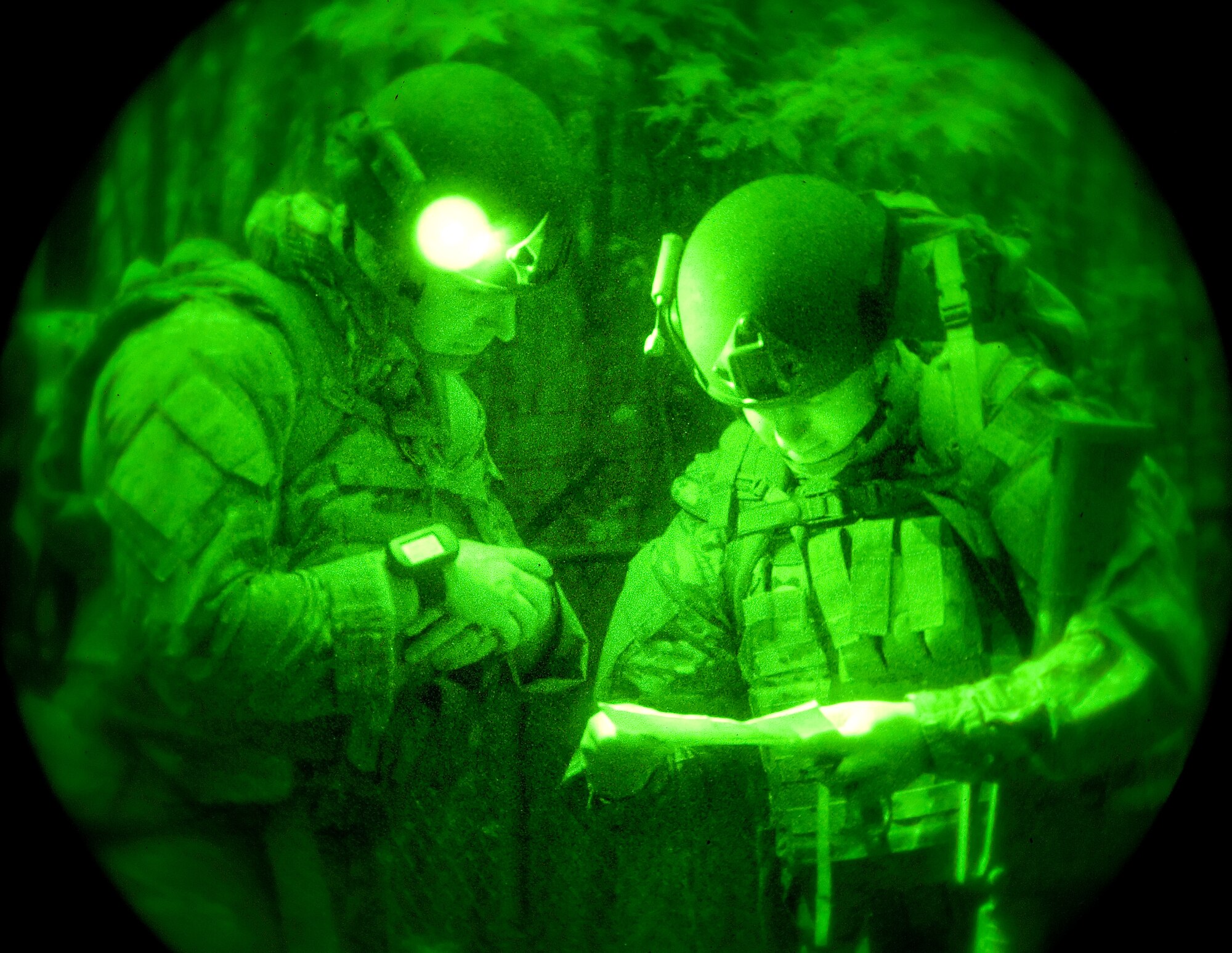 Capt. John Fuson, 436th Civil Engineer Squadron Explosive Ordnance Disposal flight commander, left, and Staff Sgt. Carl Dill, 436th CES EOD technician, right, simulate calling in landing zone position coordinates Oct. 10, 2014, on Dover Air Force Base, Del. Fuson and Dill simulated communication with friendly forces for the extraction of two wounded EOD patrol members with simulated gunshot wounds. (U.S. Air Force photo/Roland Balik)