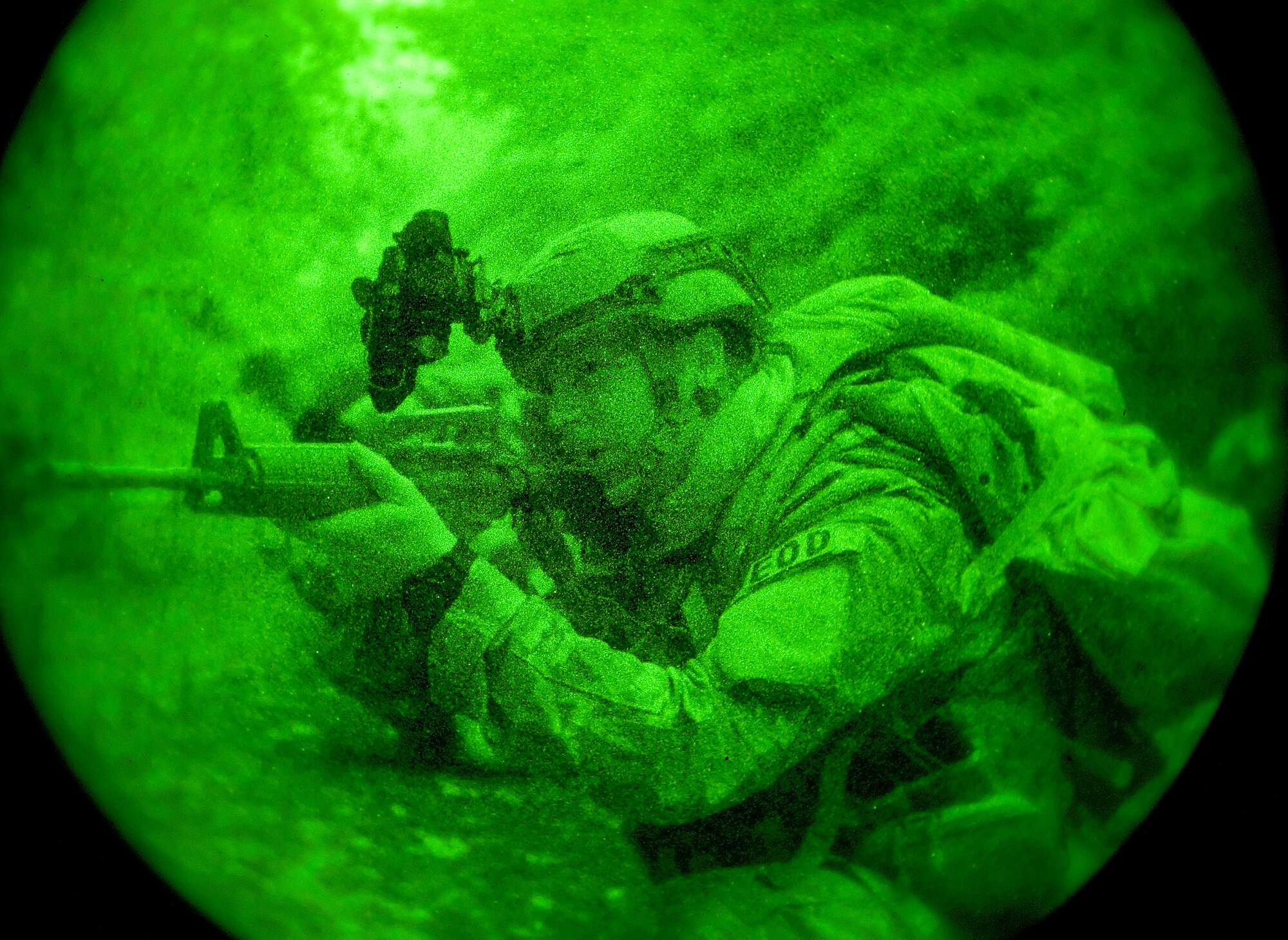 Airman 1st Class Colby Hillman, 436th Civil Engineer Squadron Explosive Ordnance Disposal technician, takes aim with his M-16 training weapon Oct. 10, 2014, on Dover Air Force Base, Del. Hillman and other EOD personnel simulated coming under attack while on patrol and took defensive positions. (U.S. Air Force photo/Roland Balik)