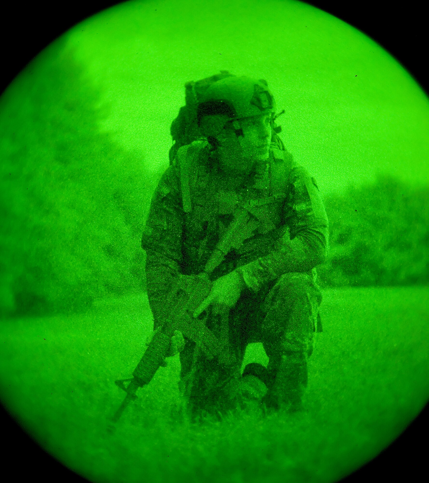 Airman 1st Class Andrew Vitale, 436th Civil Engineer Squadron Explosive Ordnance Disposal technician, looks around his surroundings while on a simulated patrol Oct. 10, 2014, on Dover Air Force Base, Del. Vitale and other EOD personnel moved under the cover of darkness along the perimeter of the base prior to sunrise during a soldiering skills training event. (U.S. Air Force photo/Roland Balik)