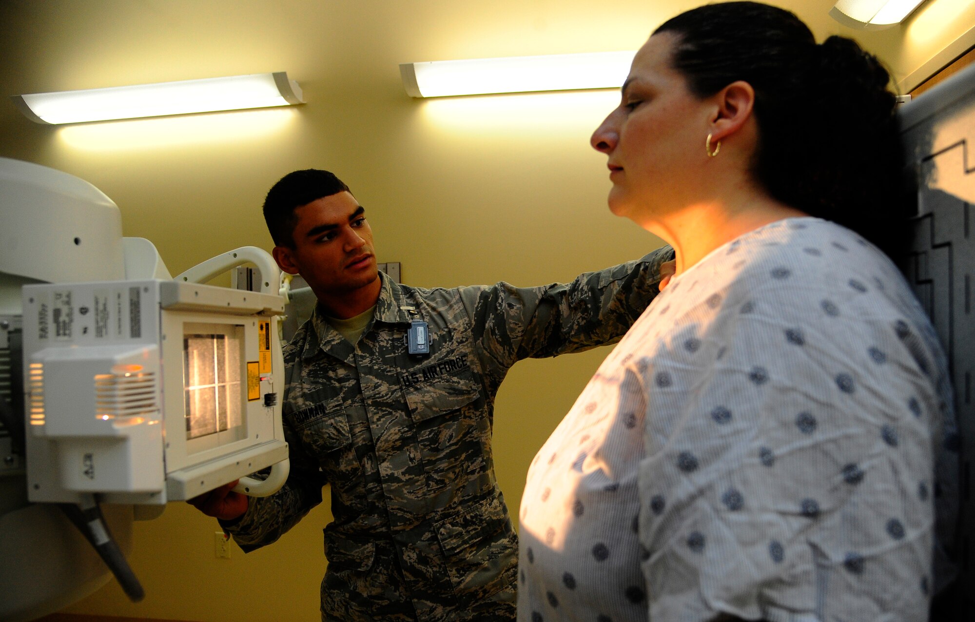 Airman 1st Class James Bowman, Phase II radiology technologist student, positions a patient for a mid- back x-ray Oct. 9, 2014 at MacDill Air Force Base, Fla. Bowman is one of four students currently in the Radiology Phase II Technical School here at MacDill. (U.S. Air Force photo by Senior Airman Jenay Randolph/Released)