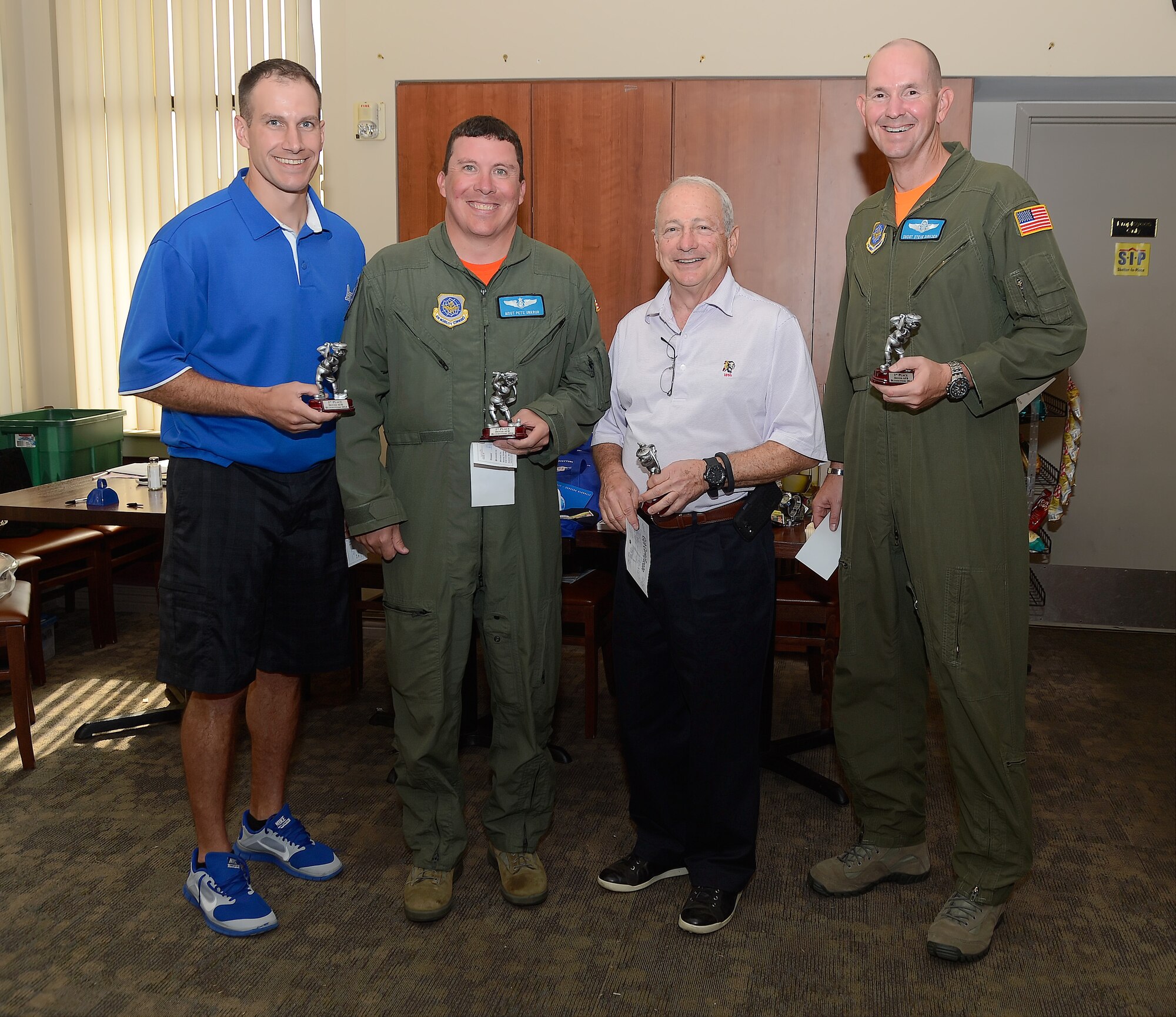 Group photo of contest winners who participated in the 436th Airlift Wing's 2014 Fall Bluesuiters Golf Tournament at Eagle's Landing Golf Course, Dover Air Force Base, Del., on Oct. 3, 2014. Key military leaders from Dover AFB were paired with local civic and business leaders for the Bluesuiters Golf Tournament as part of Dover's robust community outreach program. Dover AFB enjoys outstanding support from surrounding communities and events like this cement those ties. (U.S. Air Force photo/Greg L. Davis)