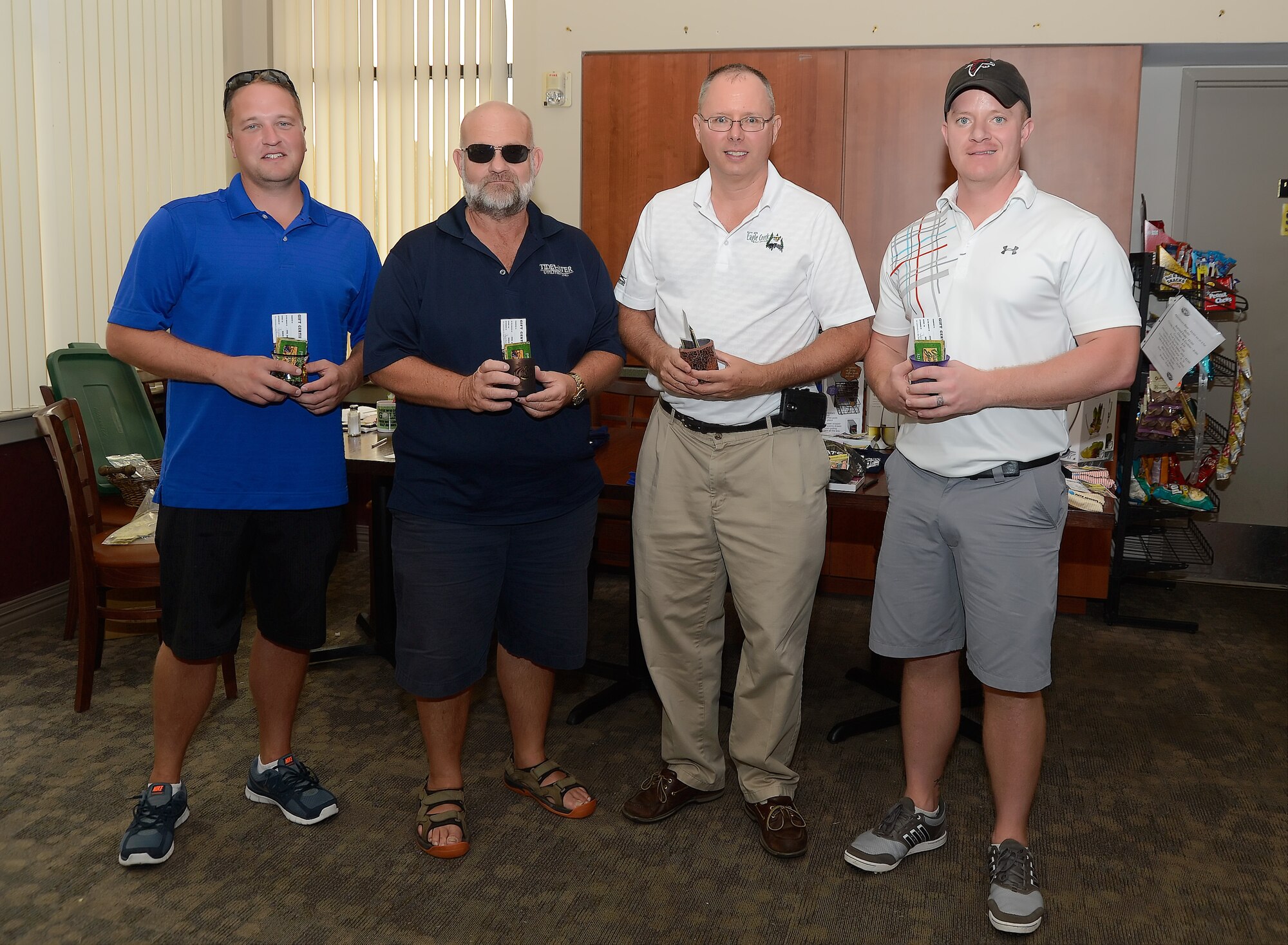 Group photo of contest winners who participated in the 436th Airlift Wing's 2014 Fall Bluesuiters Golf Tournament at Eagle's Landing Golf Course, Dover Air Force Base, Del., on Oct. 3, 2014. Key military leaders from Dover AFB were paired with local civic and business leaders for the Bluesuiters Golf Tournament as part of Dover's robust community outreach program. Dover AFB enjoys outstanding support from surrounding communities and events like this cement those ties. (U.S. Air Force photo/Greg L. Davis)