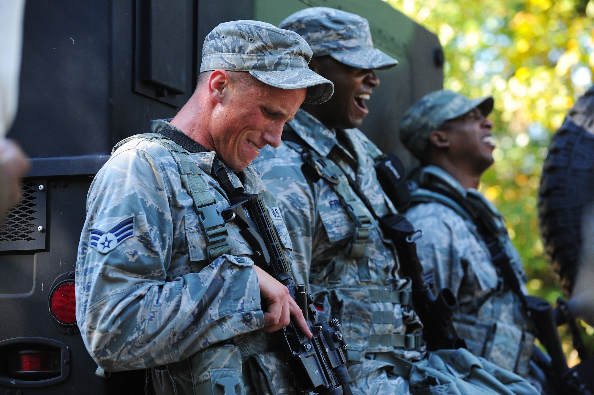 (From left) U.S. Air Force Senior Airman Zachary Gartmann, 20th Security Forces Squadron entry controller, Airman 1st Class Tyler Frazier, 20th SFS patrolman, and Staff Sgt. Corey Wright, 20th SFS patrolman, push a Humvee during the Defenders Edge Challenge at Shaw Air Force Base, S.C., Oct. 8, 2014. During the challenge, Airmen had 30 minutes to complete 10 challenges. (U.S. Air Force photo by Airman 1st Class Michael Cossaboom/Released)
