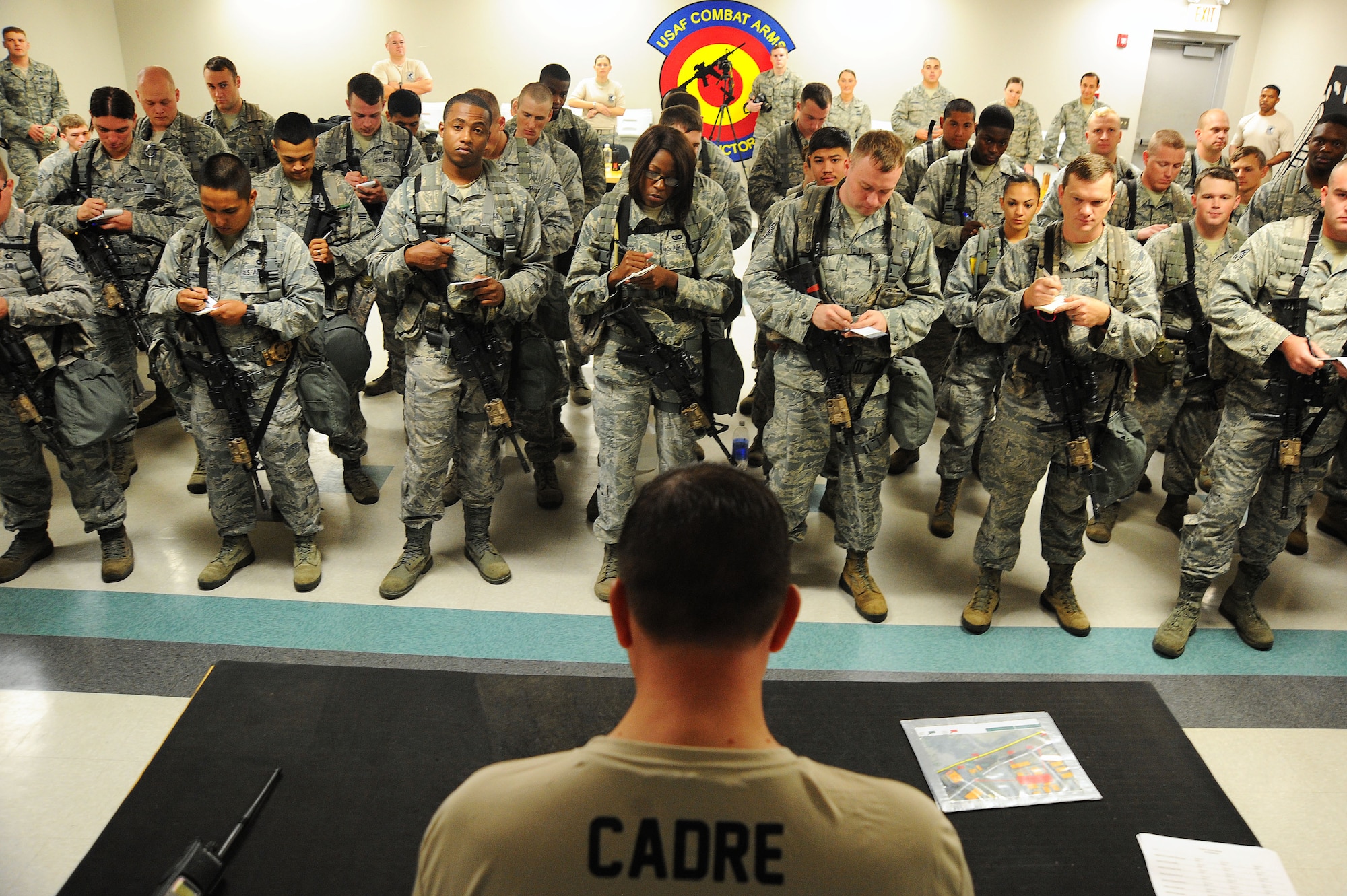 U.S. Air Force Chief Master Sgt. Scott Henshaw, 20th Security Forces Squadron manager, briefs Airmen on the tasks they will be performing during their Defenders Edge Challenge at Shaw Air Force Base, S.C., Oct. 8, 2014. Eight teams of four Airmen raced against the clock to complete 10 tasks. (U.S. Air Force photo by Airman 1st Class Michael Cossaboom/Released)