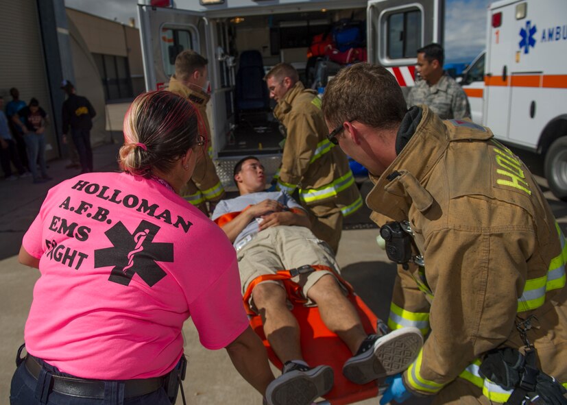 Members of the 49th Medical Group and the 49th Civil Engineer Squadron Fire Protection Flight transport victim participants to safety during an active shooter exercise at Holloman Air Force Base, N.M., Oct. 9. Holloman maintains readiness to respond to emergencies such as active shooters by conducting training exercises multiple times a year. Members from the 49th Security Forces Squadron, 49th Civil Engineer Squadron and the 49th Medical Group were able to quickly respond to the exercise scenario, neutralize the threats and evacuate the victims. (U.S. Air Force photo by Airman 1st Class Aaron Montoya / Released)