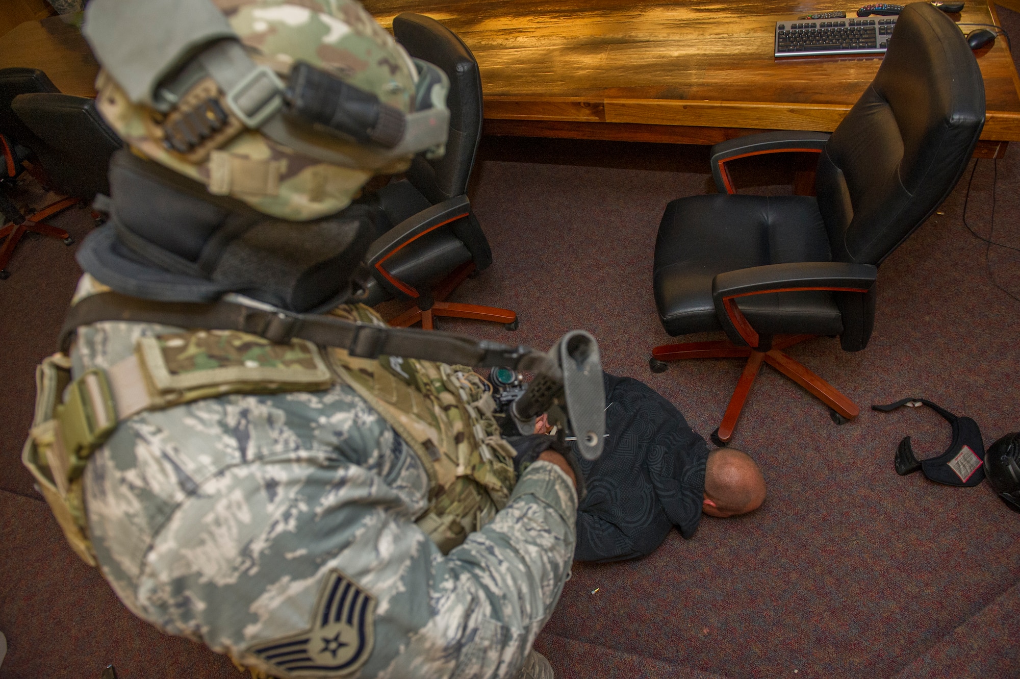 A member of the 49th Security Forces Squadron maintains control of a subdued hostile during an active shooter exercise at Holloman Air Force Base, N.M., Oct. 9. Holloman maintains readiness to respond to emergencies such as active shooters by conducting training exercises multiple times a year. Members from the 49th Security Forces Squadron, 49th Civil Engineer Squadron and the 49th Medical Group were able to quickly respond to the exercise scenario, neutralize the threats and evacuate the victims. (U.S. Air Force photo by Airman 1st Class Aaron Montoya / Released)