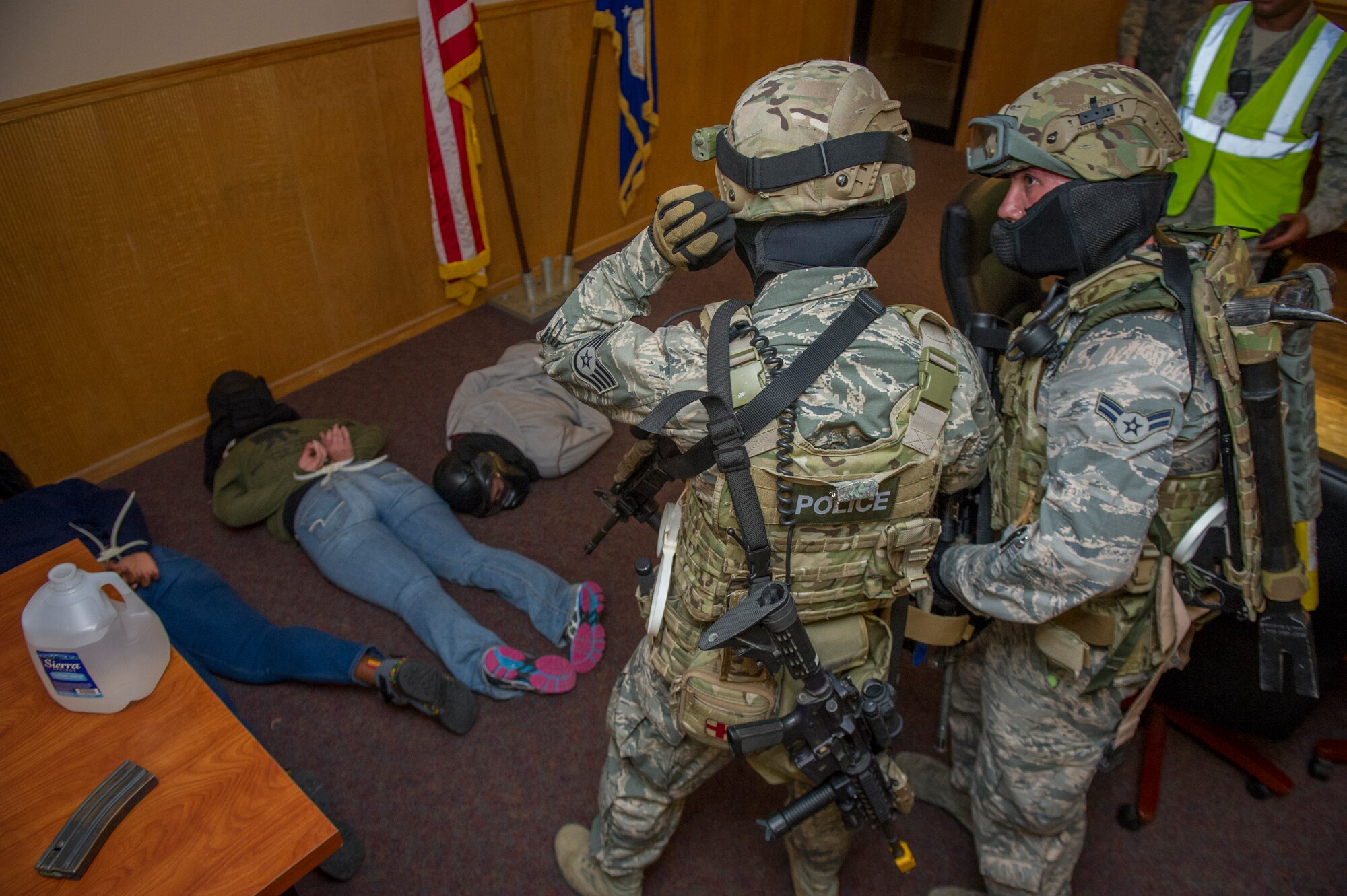 Members of the 49th Security Forces Squadron check on the welfare of hostage participants after the hostile was subdued during an active shooter exercise at Holloman Air Force Base, N.M., Oct. 9. Holloman maintains readiness to respond to emergencies such as active shooters by conducting training exercises multiple times a year. Members from the 49th Security Forces Squadron, 49th Civil Engineer Squadron and the 49th Medical Group were able to quickly respond to the exercise scenario, neutralize the threats and evacuate the victims. (U.S. Air Force photo by Airman 1st Class Aaron Montoya / Released)