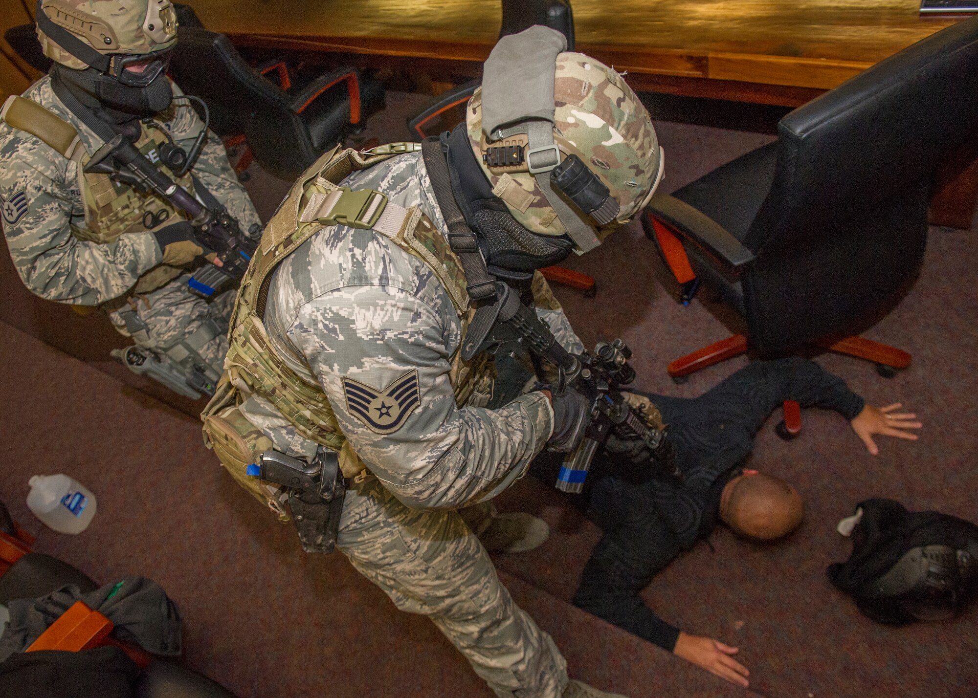 Members of the 49th Security Forces Squadron subdue a hostile player during an active shooter exercise at Holloman Air Force Base, N.M., Oct. 9. Holloman exercises to maintain readiness in order to respond to emergencies such as active shooters. Members from the 49th Security Forces Squadron, 49th Civil Engineer Squadron and the 49th Medical Group were able to quickly respond to the exercise scenario, neutralize the threats and evacuate the victims. (U.S. Air Force photo by Airman 1st Class Aaron Montoya / Released)