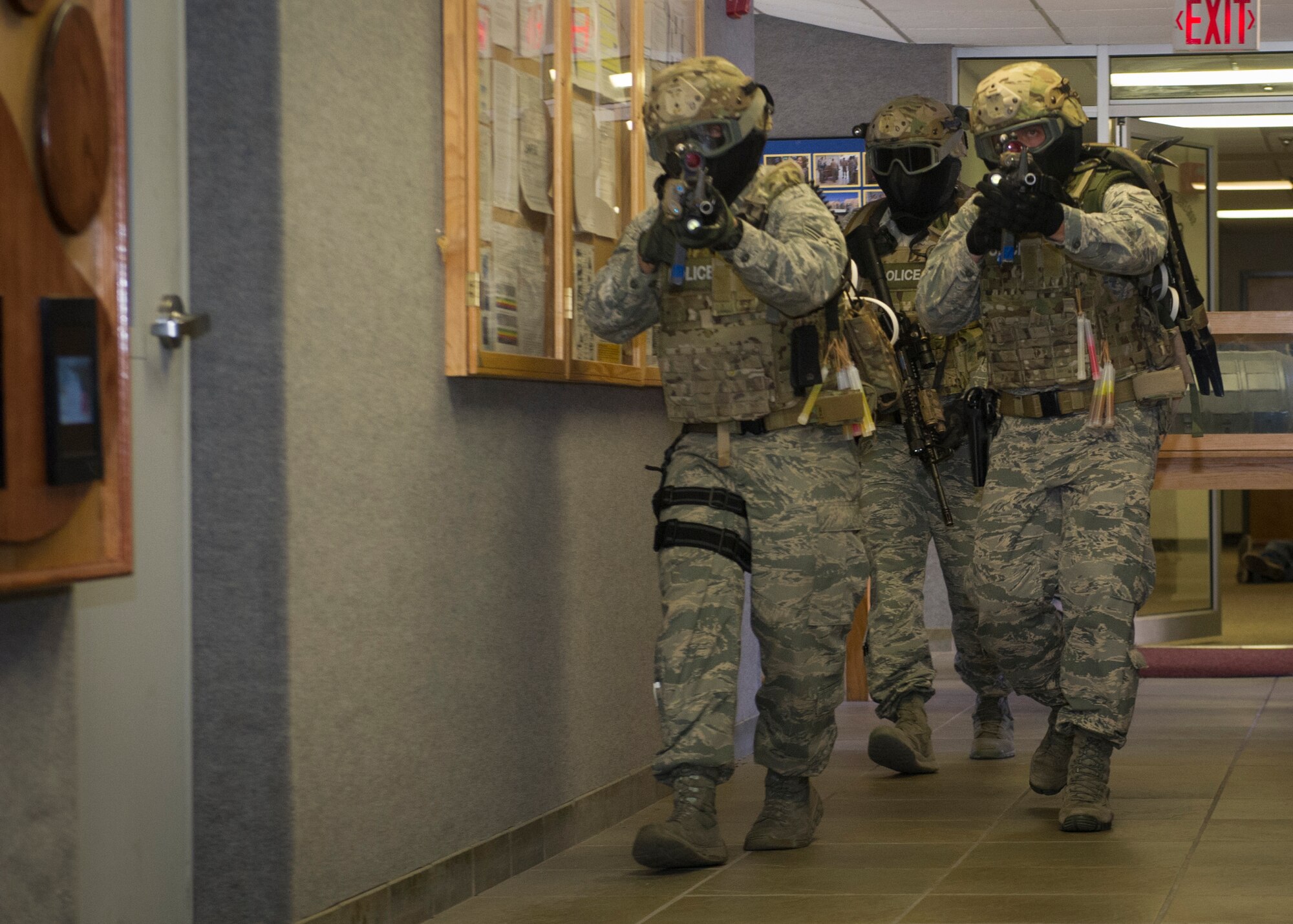 Members of the 49th Security Forces Squadron attempt to neutralize the threat by clearing rooms and checking for hostiles during an active shooter exercise at Holloman Air Force Base, N.M., Oct. 9. Holloman maintains readiness to respond to emergencies such as active shooters by conducting training exercises multiple times a year. Members from the 49th Security Forces Squadron, 49th Civil Engineer Squadron and the 49th Medical Group were able to quickly respond to the exercise scenario, neutralize the threats and evacuate the victims. (U.S. Air Force photo by Airman 1st Class Aaron Montoya / Released)