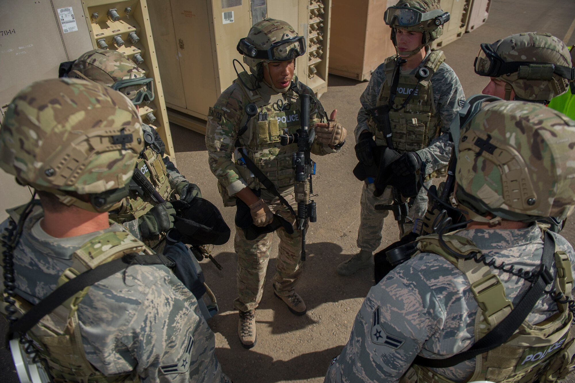 Members of the 49th Security Forces Squadron utilize transmitted information to devise a proper strategy for attack during an active shooter exercise at Holloman Air Force Base, N.M., Oct. 9. Holloman maintains readiness to respond to emergencies such as active shooters by conducting training exercises multiple times a year. Members from the 49th Security Forces Squadron, 49th Civil Engineer Squadron and the 49th Medical Group were able to quickly respond to the exercise scenario, neutralize the threats and evacuate the victims. (U.S. Air Force photo by Airman 1st Class Aaron Montoya / Released)