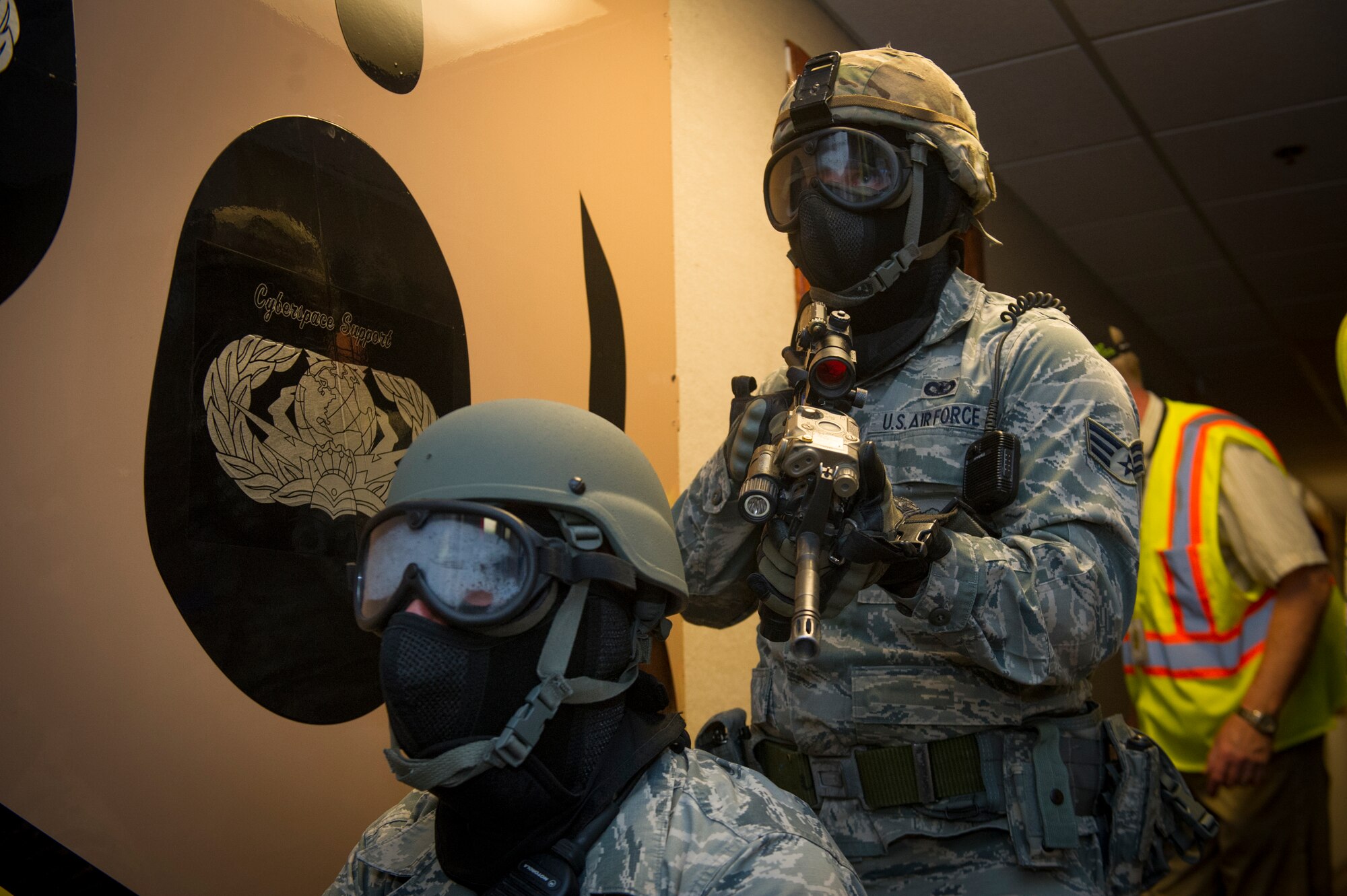 Members of the 49th Security Forces Squadron clear rooms while checking for hostiles during an active shooter exercise at Holloman Air Force Base, N.M., Oct. 9. Holloman maintains readiness to respond to emergencies such as active shooters by conducting training exercises multiple times a year. Members from the 49th Security Forces Squadron, 49th Civil Engineer Squadron and the 49th Medical Group were able to quickly respond to the exercise scenario, neutralize the threats and evacuate the victims. (U.S. Air Force photo by Airman 1st Class Aaron Montoya / Released)