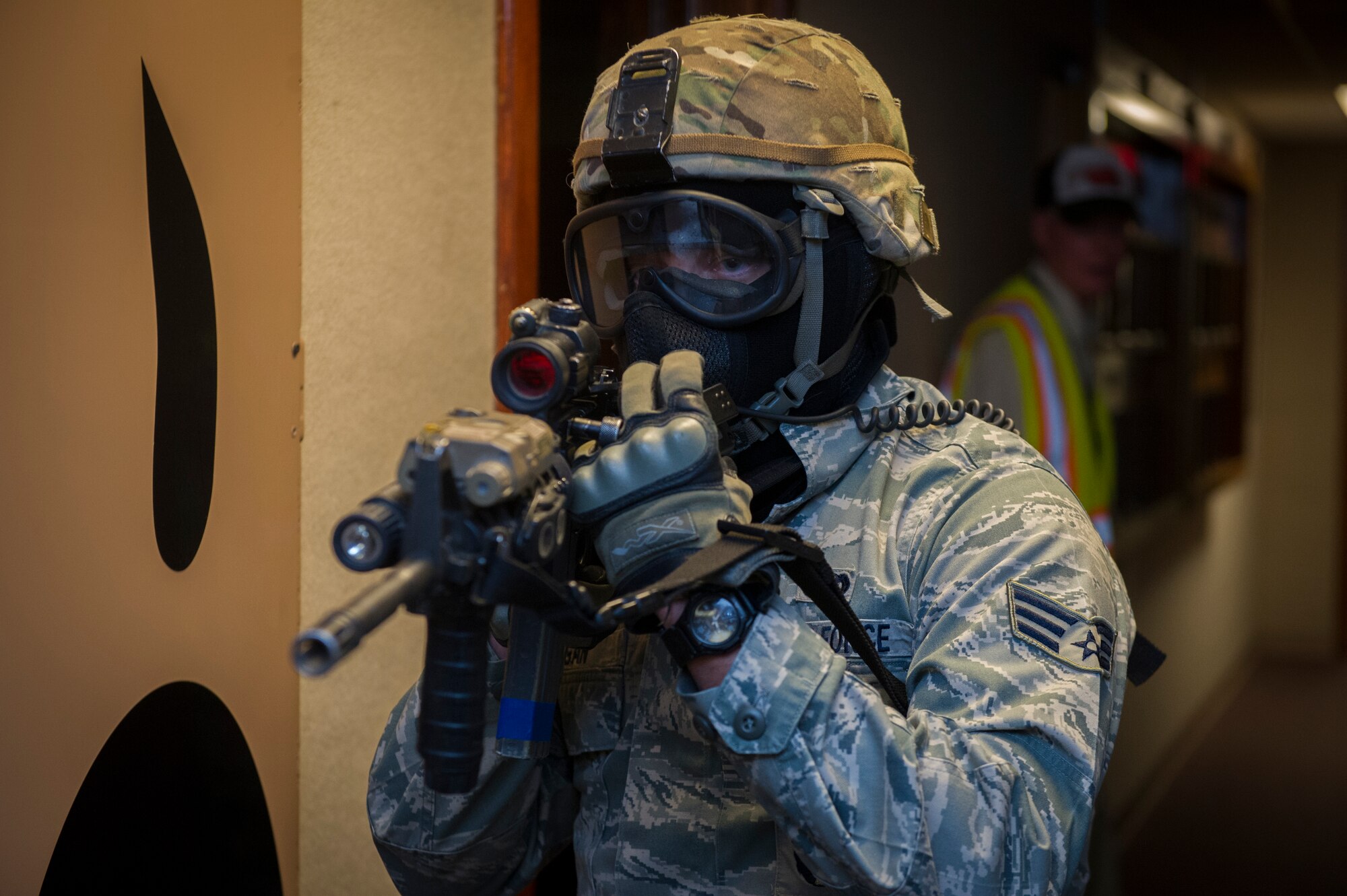 A member of the 49th Security Forces Squadron updates other first responders on the current active shooter situation to successful capture the hostile and rescue hostages during an exercise at Holloman Air Force Base, N.M., Oct. 9. Holloman maintains readiness to respond to emergencies such as active shooters by conducting training exercises multiple times a year. Members from the 49th Security Forces Squadron, 49th Civil Engineer Squadron and the 49th Medical Group were able to quickly respond to the exercise scenario, neutralize the threats and evacuate the victims. (U.S. Air Force photo by Airman 1st Class Aaron Montoya / Released)