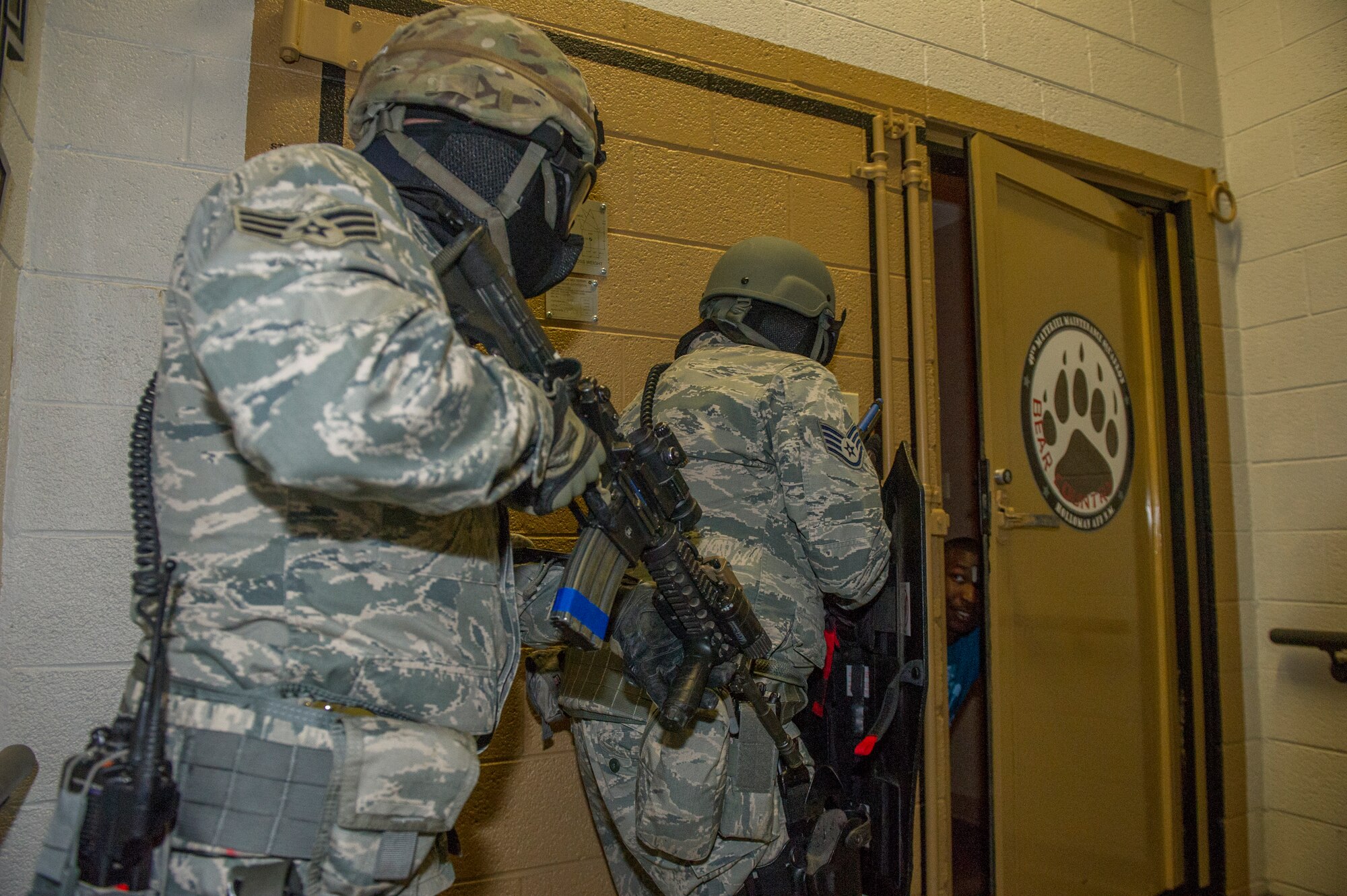 Members of the 49th Security Forces Squadron assist victim participants to safety while clearing rooms and looking for hostiles during an active shooter exercise at Holloman Air Force Base, N.M., Oct. 9. Holloman exercises to maintain readiness in order to respond to emergencies such as active shooters. Members from the 49th Security Forces Squadron, 49th Civil Engineer Squadron and the 49th Medical Group were able to quickly respond to the exercise scenario, neutralize the threats and evacuate the victims. (U.S. Air Force photo by Airman 1st Class Aaron Montoya / Released)