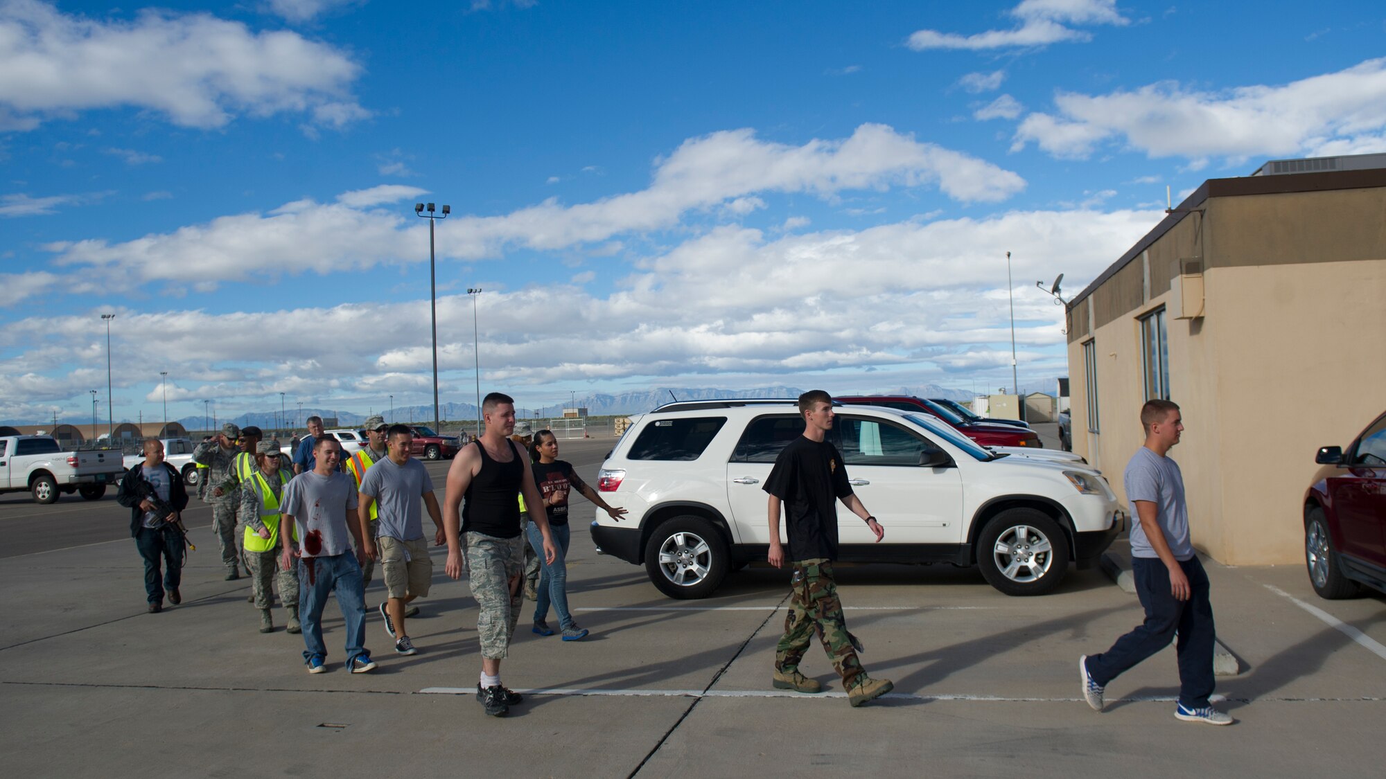 Holloman Airmen who volunteered to participate in the active shooter exercise head to the staging area to kick off the exercise at Holloman Air Force Base, N.M., Oct. 9. Holloman maintains readiness to respond to emergencies such as active shooters by conducting training exercises multiple times a year. Members from the 49th Security Forces Squadron, 49th Civil Engineer Squadron and the 49th Medical Group were able to quickly respond to the exercise scenario, neutralize the threats and evacuate the victims. (U.S. Air Force photo by Airman 1st Class Aaron Montoya / Released)