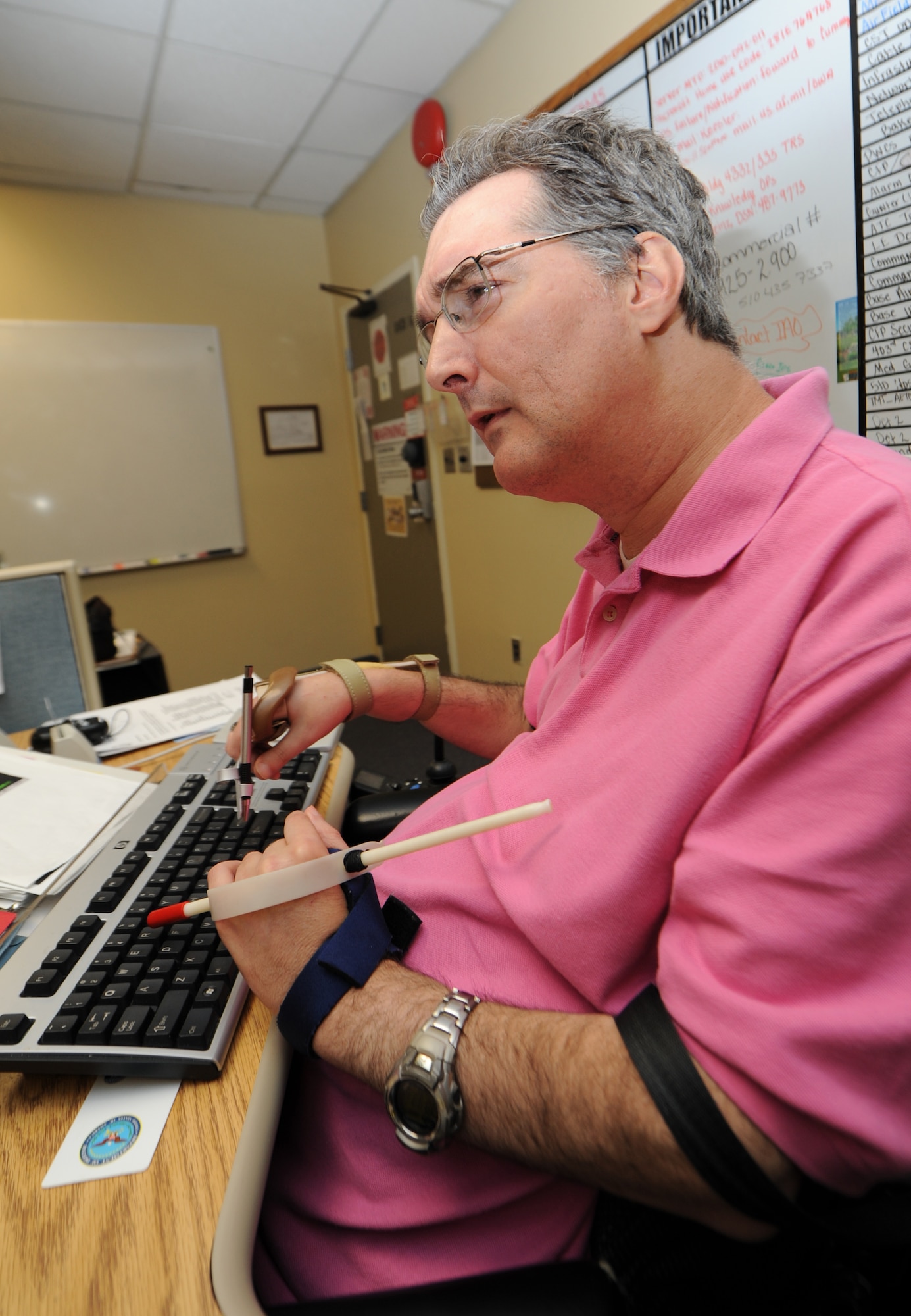 Billy Harrison, 81st Communications Squadron, actively monitors the Air Force Information Networks-Global Information Grid Oct. 8, 2014, at the 81st CS, Keesler Air Force Base, Miss.  Harrison, a quadriplegic, has been employed at Keesler for almost 20 years.  (U.S. Air Force photo by Kemberly Groue)