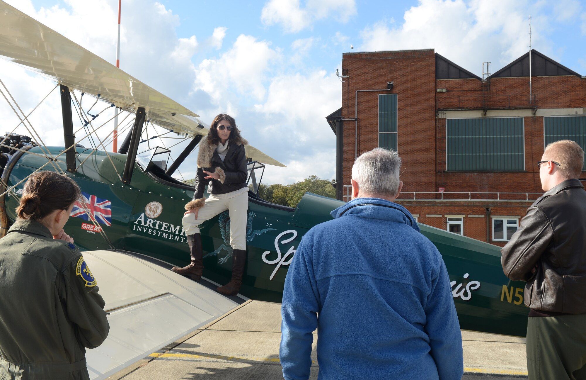 Tracey Curtis-Taylor, aviation enthusiast from Goodwood, England, shows her Boeing Stearman biplane to Team Mildenhall Airmen Oct. 10, 2014, on RAF Mildenhall, England. The biplane carried Tracey Curtis-Taylor on her 10,000 mile journey across Africa in 2013. (U.S. Air Force photo/Airman 1st Class Kyla Gifford/Released)