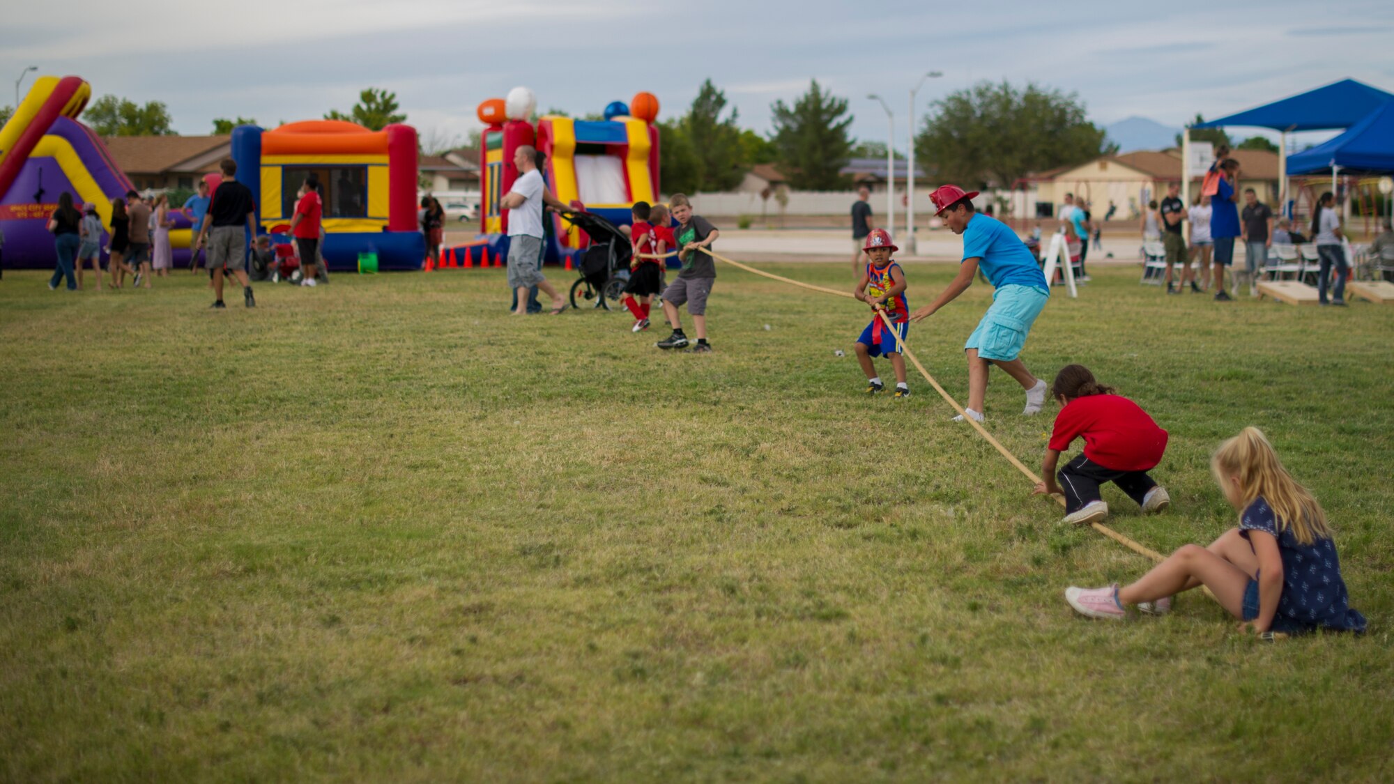 Team Holloman dependents play tug of war during the National Night Out event hosted by the Soaring Heights community office at Holloman Air Force Base, N.M., Oct. 7. The night out event is a community-based event that increases awareness about safety programs in local communities, such as drug prevention, neighborhood watch and other anti-crime efforts. This is the seventh year Soaring Heights has hosted the event and brought together 11 law enforcement, fire protection and community support agencies to provide Holloman residents information and child safety material. The National Night Out is also an opportunity for the 49th Security Forces Squadron to demonstrate how they keep the base safe through defensive tactics and military working dog demonstrations. (U.S. Air Force photo by Airman 1st Class Aaron Montoya / Released)