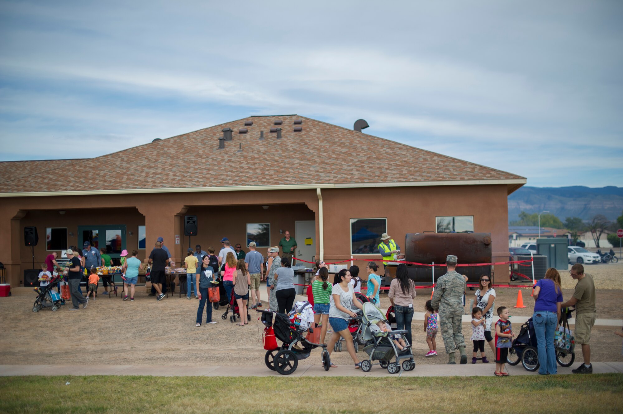Holloman Airmen and their families gather for food and drinks during the National Night Out event hosted by the Soaring Heights community office at Holloman Air Force Base, N.M., Oct. 7. The night out event is a community-based event that increases awareness about safety programs in local communities, such as drug prevention, neighborhood watch and other anti-crime efforts. This is the seventh year Soaring Heights has hosted the event and brought together 11 law enforcement, fire protection and community support agencies to provide Holloman residents information and child safety material. The National Night Out is also an opportunity for the 49th Security Forces Squadron to demonstrate how they keep the base safe through defensive tactics and military working dog demonstrations. (U.S. Air Force photo by Airman 1st Class Aaron Montoya / Released)