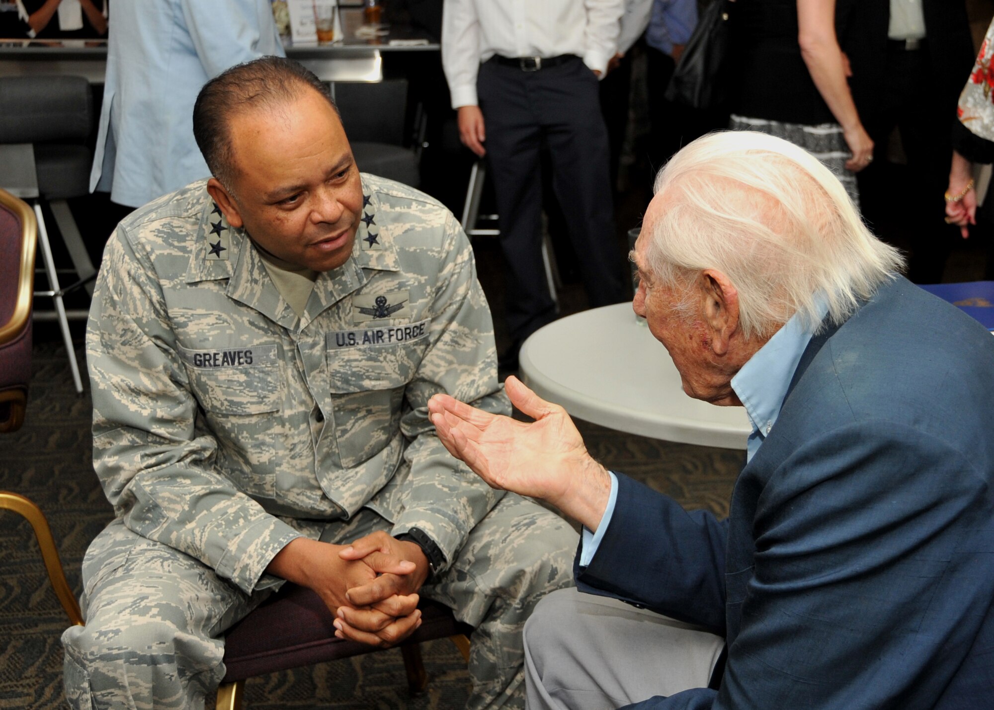 U.S. Air Force Lt. Gen. Sam Greaves, commander of the Space and Missile Systems Center chats with U.S Army Air Corps Lt. Col. (Ret.) Robert L. Hecker during a function hosted by the Air Force Association’s Bernard Schriever Chapter 147 at Los Angeles Air Force Base on October 3, 2014.  Lt. Col. Hecker flew B-17s in thirty missions over Europe, earning five Air Medals and the Distinguished Flying Cross.  After the war, Hecker began writing for radio and television, and has since become a prolific screenwriter, playwright, and producer.  (U.S. Air Force photo by Sarah Corrice) 