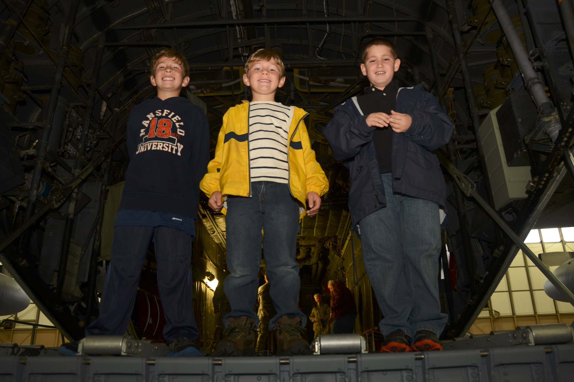 Colton Fillmore, 8, Landon Fillmore, 6, and Nathan Defreitas, 8, smile from the back of a C-130H Hercules aircraft at Bradley Air National Guard Base, East Granby, Conn., on Oct. 4. 2014. The boys are family members of employees of Fillmore Express Inc. who took part in a base tour. (Air National Guard photo by Senior Airman Jennifer Pierce)