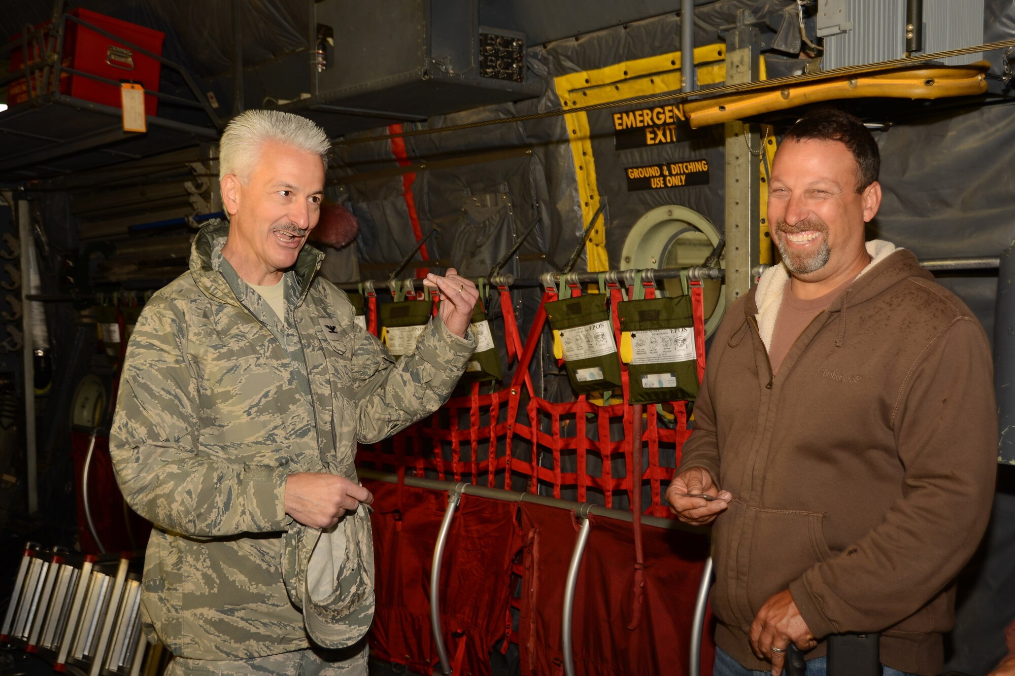 Scott Fillmore, operations manager for Fillmore Express Inc., grins after receiving a 103rd Airlift Wing challenge coin from Col. Frederick Miclon, vice commander of the 103rd Airlift Wing, at Bradley Air National Guard Base, East Granby, Conn., Oct. 4. 2014. Fillmore, along with his co-workers and their respective families, were invited to take part in a base tour to thank them for the signs they posted outside of their business showing support to the Airmen of the Connecticut Air National Guard. (Air National Guard photo by Senior Airman Jennifer Pierce)