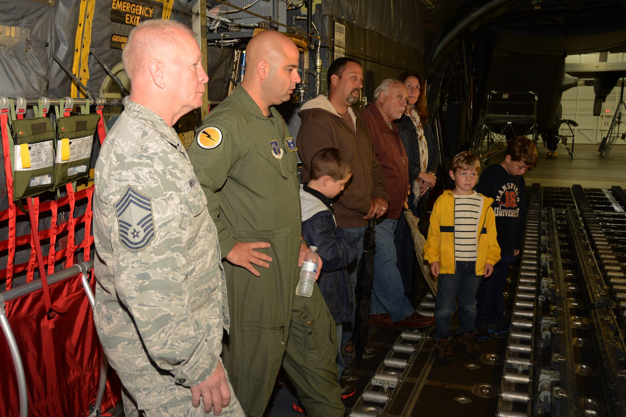 Chief Master Sgt. Patrick Wheeler, assigned to the 103rd Maintenance Squadron, and Tech. Sgt. Tufic Paone, loadmaster with the 103rd Operations Group, help conduct a tour given to Fillmore Express Inc. employees and their family members on a C-130H Hercules aircraft at Bradley Air National Guard Base, East Granby, Conn., Oct. 4. 2014. (Air National Guard photo by Senior Airman Jennifer Pierce)