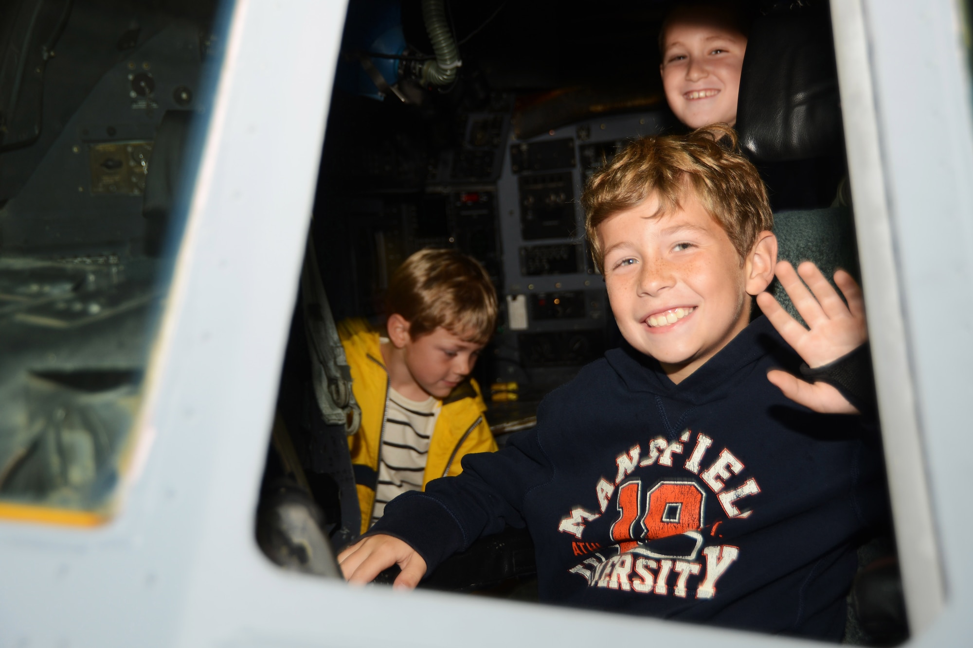 Colton Fillmore, 8, sits in the cockpit of a C-130H Hercules aircraft with Nathan Defreitas, 8, directly behind him, and Landon Fillmore, 6, on the left at Bradley Air National Guard Base, East Granby, Conn., Oct. 4, 2014. The boys participated in a base tour given to employees and their families of Fillmore Express Inc. (Air National Guard photo by Senior Airman Jennifer Pierce)
