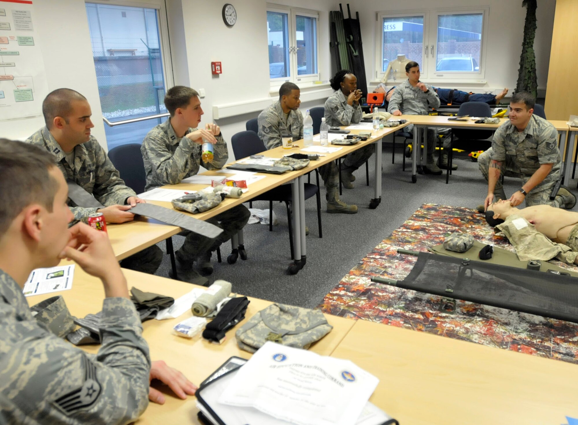 Staff Sgt. Antonio Sixto, 86th Medical Operations Squadron NCO in charge of emergency responses, demonstrates the head tilt chin lift technique during a self-aid and buddy care hands-on class at Ramstein Air Base, Germany, Oct. 7, 2014. This technique is designed to provide an open airway of an unconscious person, who does not have neck or spinal injuries. (U.S. Air Force photo/Senior Airman Timothy Moore)