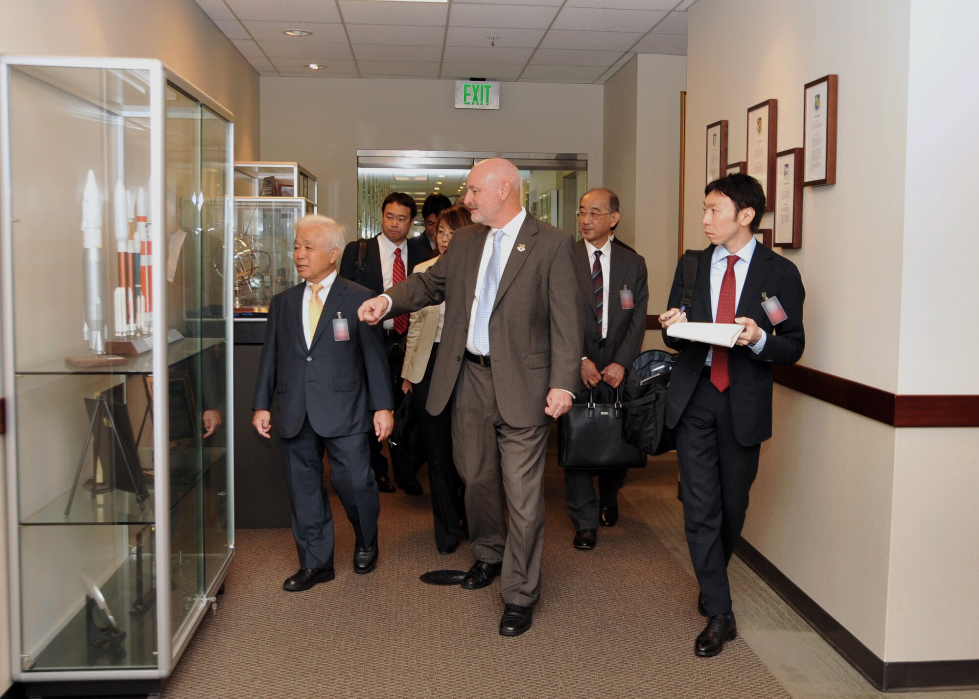 Mr. David Madden, Executive Director, Space and Missile Systems Center hosts Dr. Naoki Okumura, president of the Japanese Aerospace Exploration Agency, along with other members of a JAXA delegation during their visit to Los Angeles Air Force Base in El Segundo, Calif., on October 2, 2014. The JAXA delegation was treated to a tour of historic displays given by chief historian, Dr. Harry Waldron, and a briefing about SMC. (U.S. Air Force photo by Sarah Corrice)