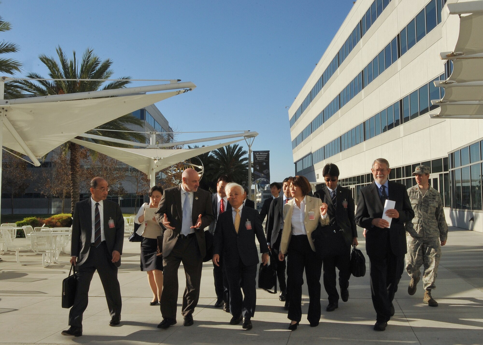 Mr. David Madden, Executive Director, Space and Missile Systems Center hosts Dr. Naoki Okumura, president of the Japanese Aerospace Exploration Agency, along with other members of a JAXA delegation during their visit to Los Angeles Air Force Base in El Segundo, Calif., on October 2, 2014. The JAXA delegation was treated to a tour of historic displays given by chief historian, Dr. Harry Waldron, and a briefing about SMC. (U.S. Air Force photo by Sarah Corrice)