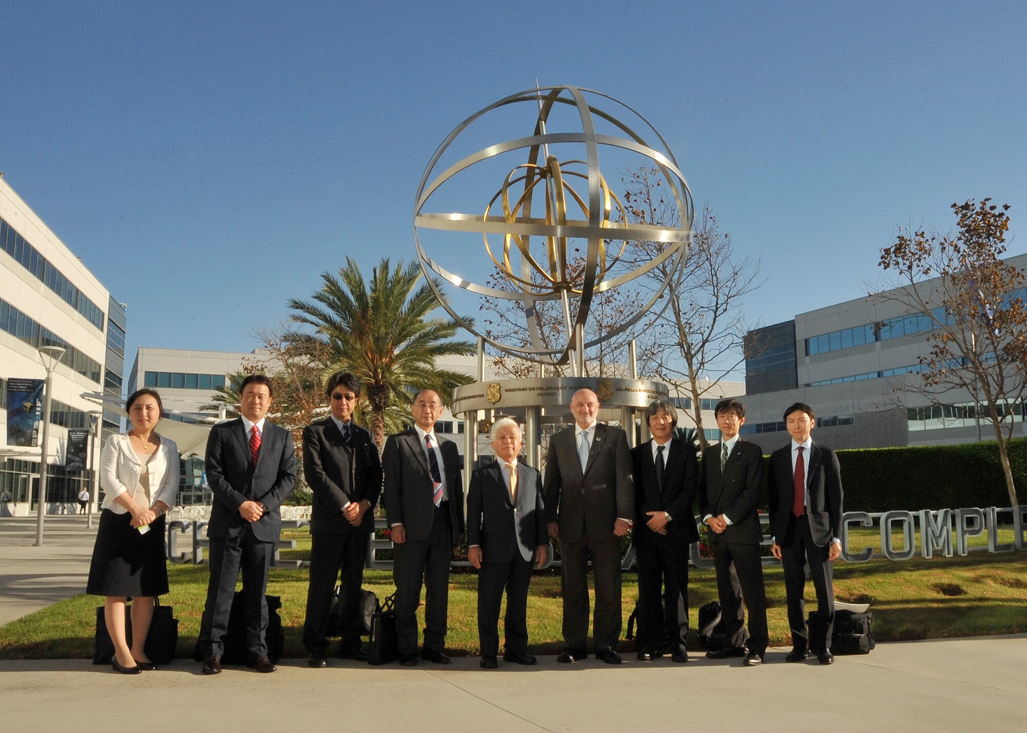 Mr. David Madden, Executive Director, Space and Missile Systems Center hosts Dr. Naoki Okumura, president of the Japanese Aerospace Exploration Agency, along with other members of a JAXA delegation during their visit to Los Angeles Air Force Base in El Segundo, Calif., on October 2, 2014. The JAXA delegation was treated to a tour of historic displays given by chief historian, Dr. Harry Waldron, and a briefing about SMC. (U.S. Air Force photo by Sarah Corrice)