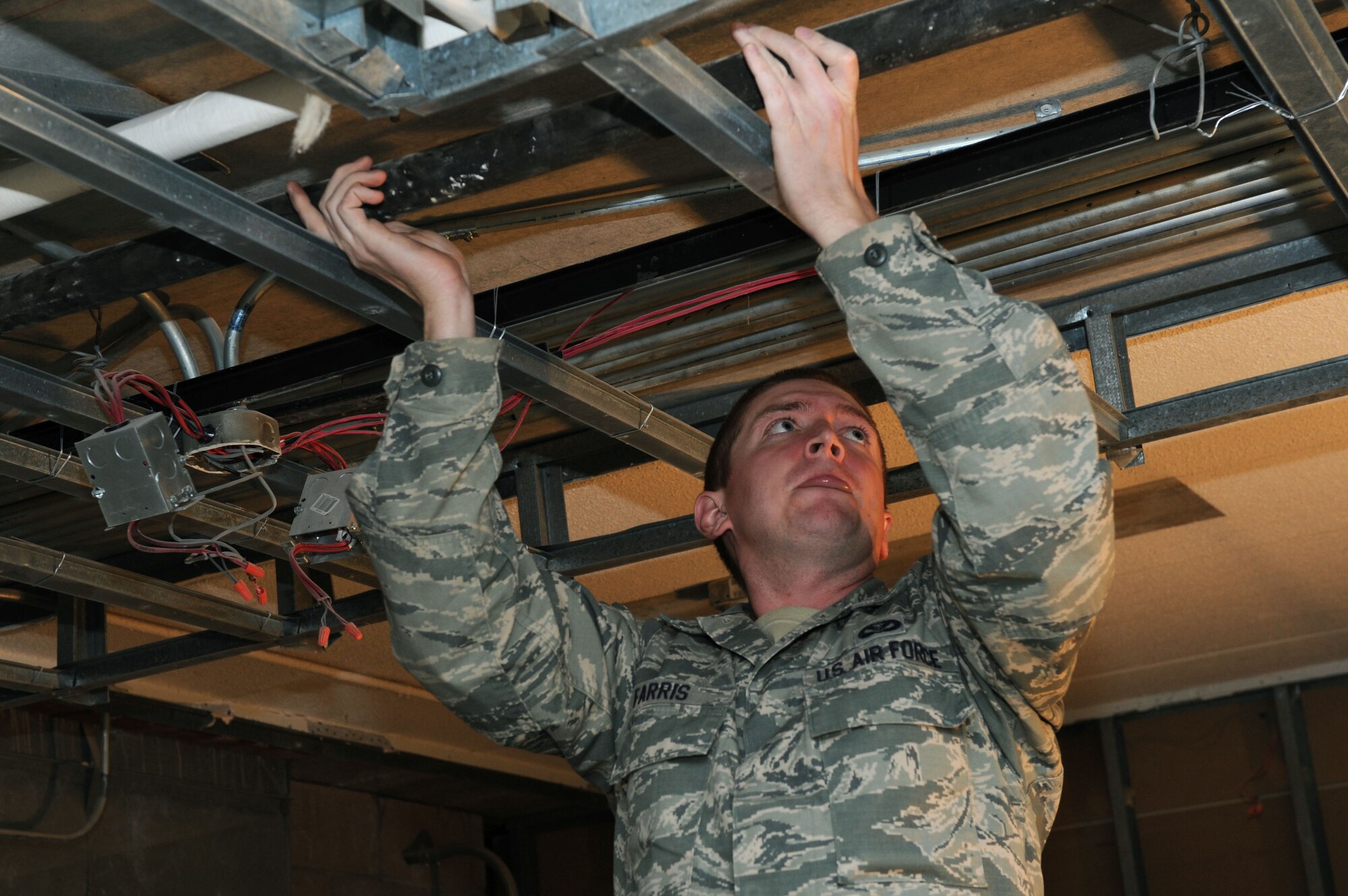 Senior Airman Jesse Farris, 28th Civil Engineer Squadron Water and Fuel System Maintenance journeyman, removes an old drain pipe from the ceiling in Borglum Hall on Ellsworth Air Force Base, S.D., Oct. 9, 2014. Airmen belonging to the WFSM section of the 28th CES are responsible for not only maintaining drain pipes, sewer lines and sprinkler systems but also the hydrogen fuel systems of Ellsworth’s aircraft. (U.S. Air Force photo by Senior Airman Hailey R. Staker/Released)  