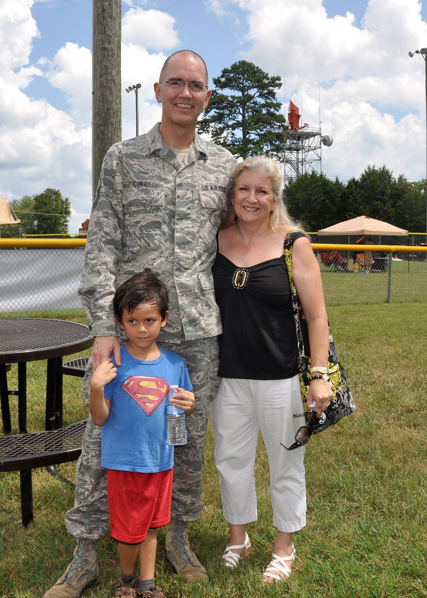 Master Sgt. George Curry, first sergeant for the 94th Communication Squadron, navigates through Family Day with his wife Lisa and grandson Jeremiah Sept. 6, 2014, at Dobbins Air Reserve Base, Ga. Family Day is an opportunity for families to show their thanks and support to reserve members. (U.S. Air Force photo by Staff Sgt. Karla V. Lehman/Released).