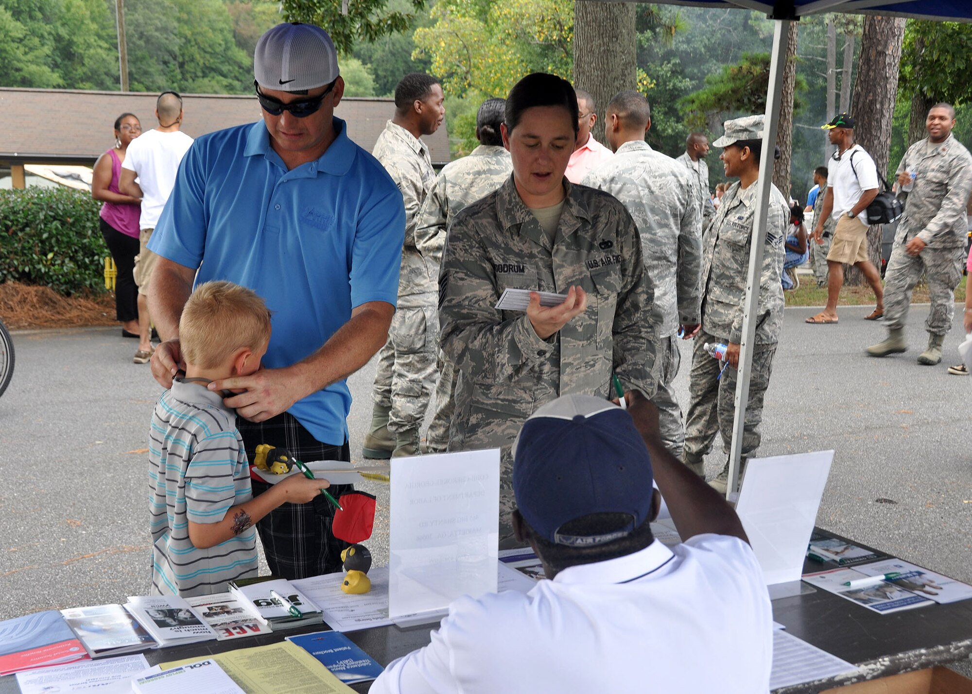 TSgt Chari Woodrum, 80th Aerial Port Squadron, navigates through Family Day  with her husband Michael and son Samuel  Sept. 6, 2014 at Dobbins Air Reserve Base, Ga. Family Day is an annual event celebrating the support family member gives Dobbins Airmen.