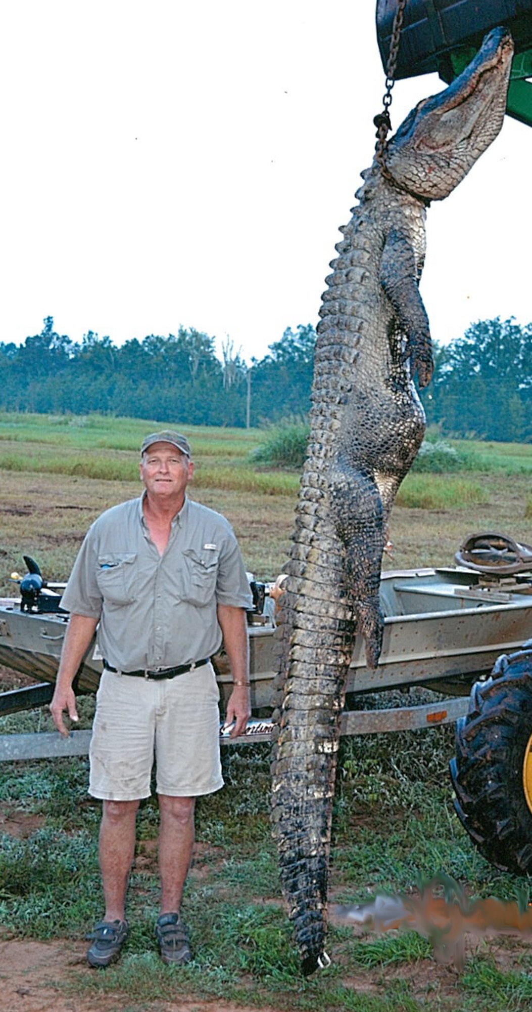 Tom Hutcheson poses with an alligator he killed at Duck Lake Sept. 18. The animal was 12-feet long and weighed 450 pounds. Hutcheson, along with Barry White and Staff Sgt. Joshua Hodges, base employees, harvested the animal with a crossbow. (Courtesy photo)
