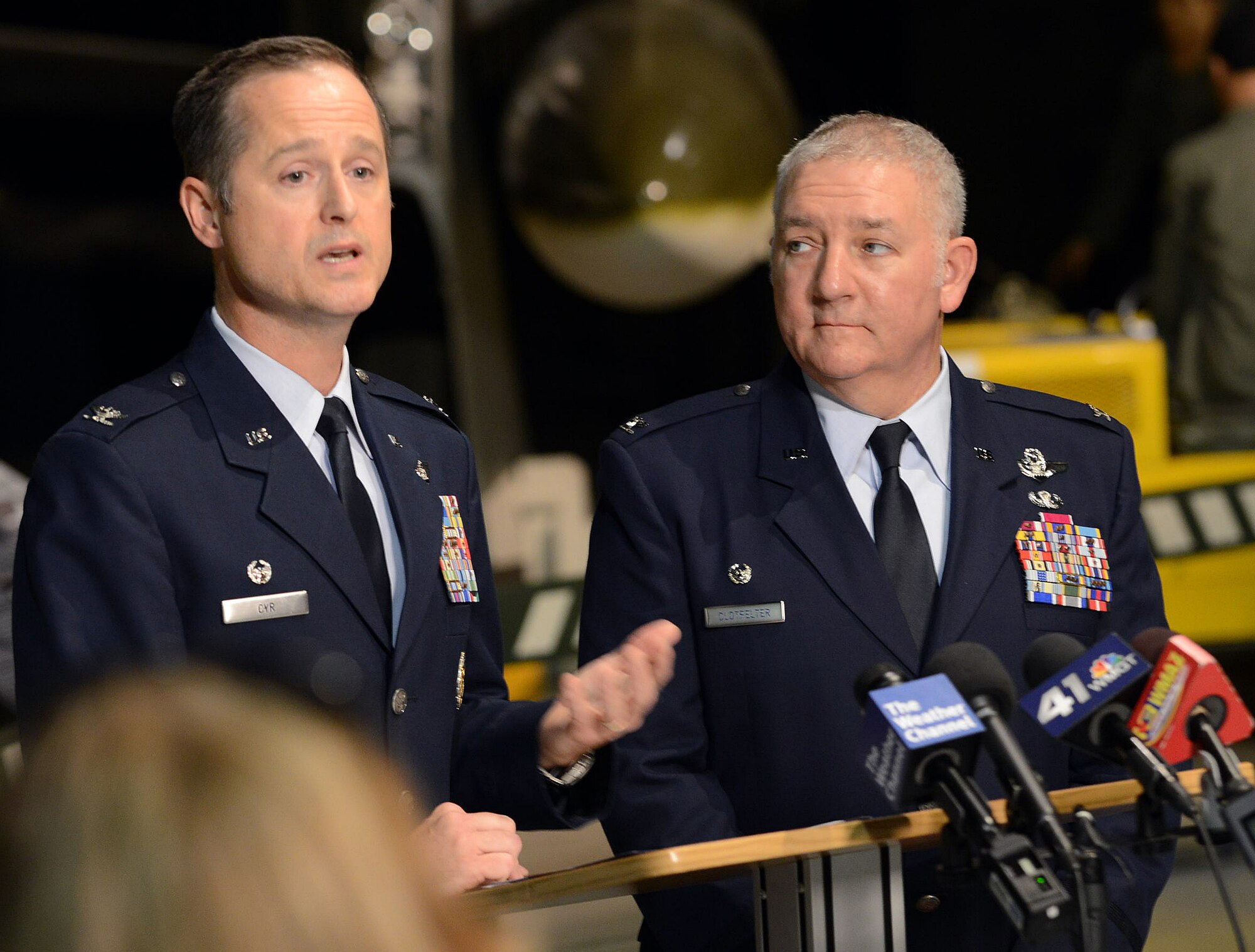 Commanders Col. Henry Cyr, left, 461st Air Control Wing, and Col. Kevin Clotfelter, 116th ACW, address media at a press conference in the Museum of Aviation, Oct. 8, 2014. (U.S. Air Force photo by Tommie Horton)