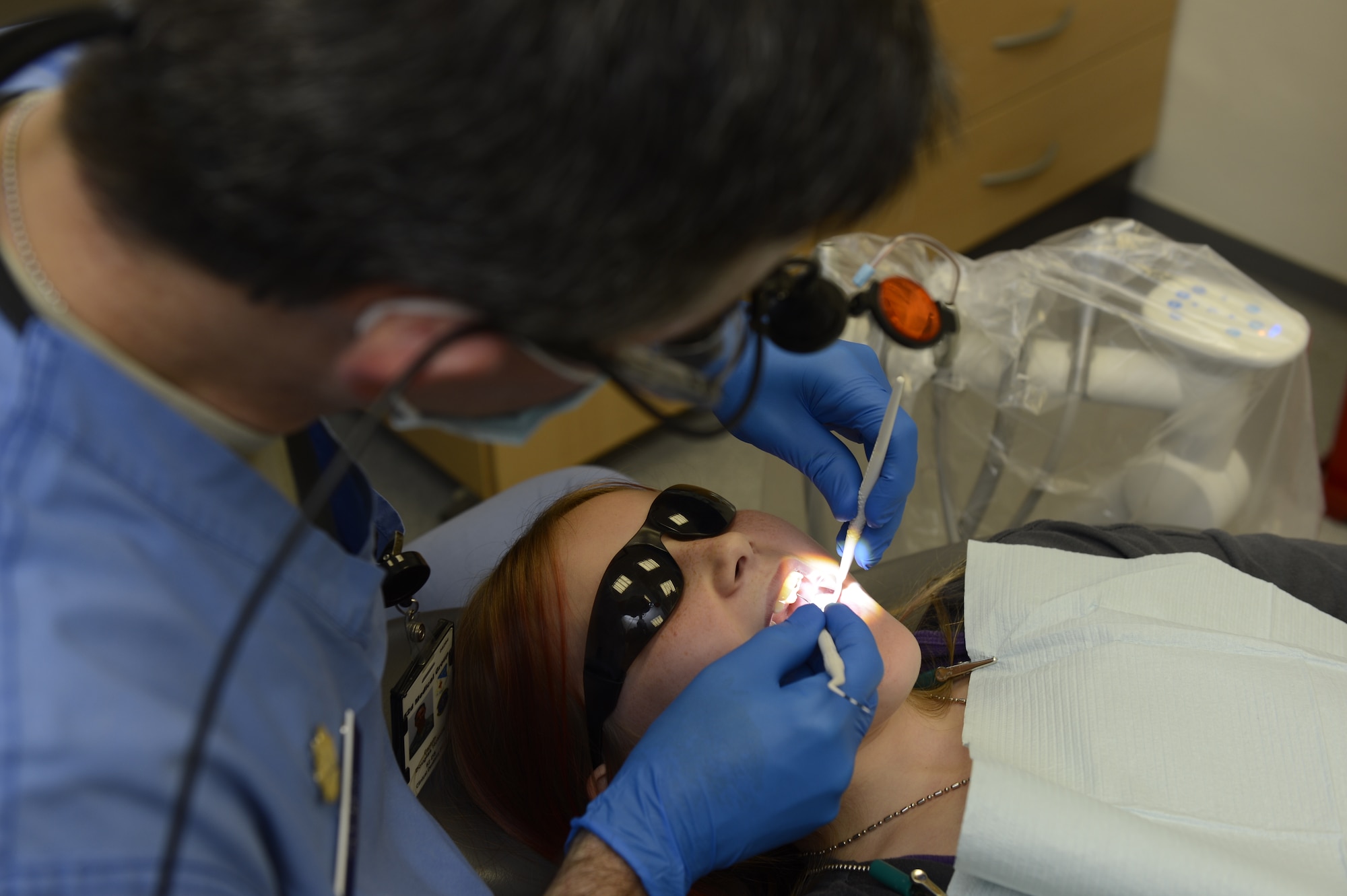 U.S. Air Force Maj. Douglas Holmes, 52nd Dental Squadron general dentist, inspects a patient for cavities during a walk-in children dental clinic at Spangdahlem Air Base, Germany, Oct. 10, 2014. The children’s dental clinic is held semi-annually for Spangdahlem and its surrounding geographically separated units. (U.S. Air Force photo by Staff Sgt. Christopher Ruano/Released)