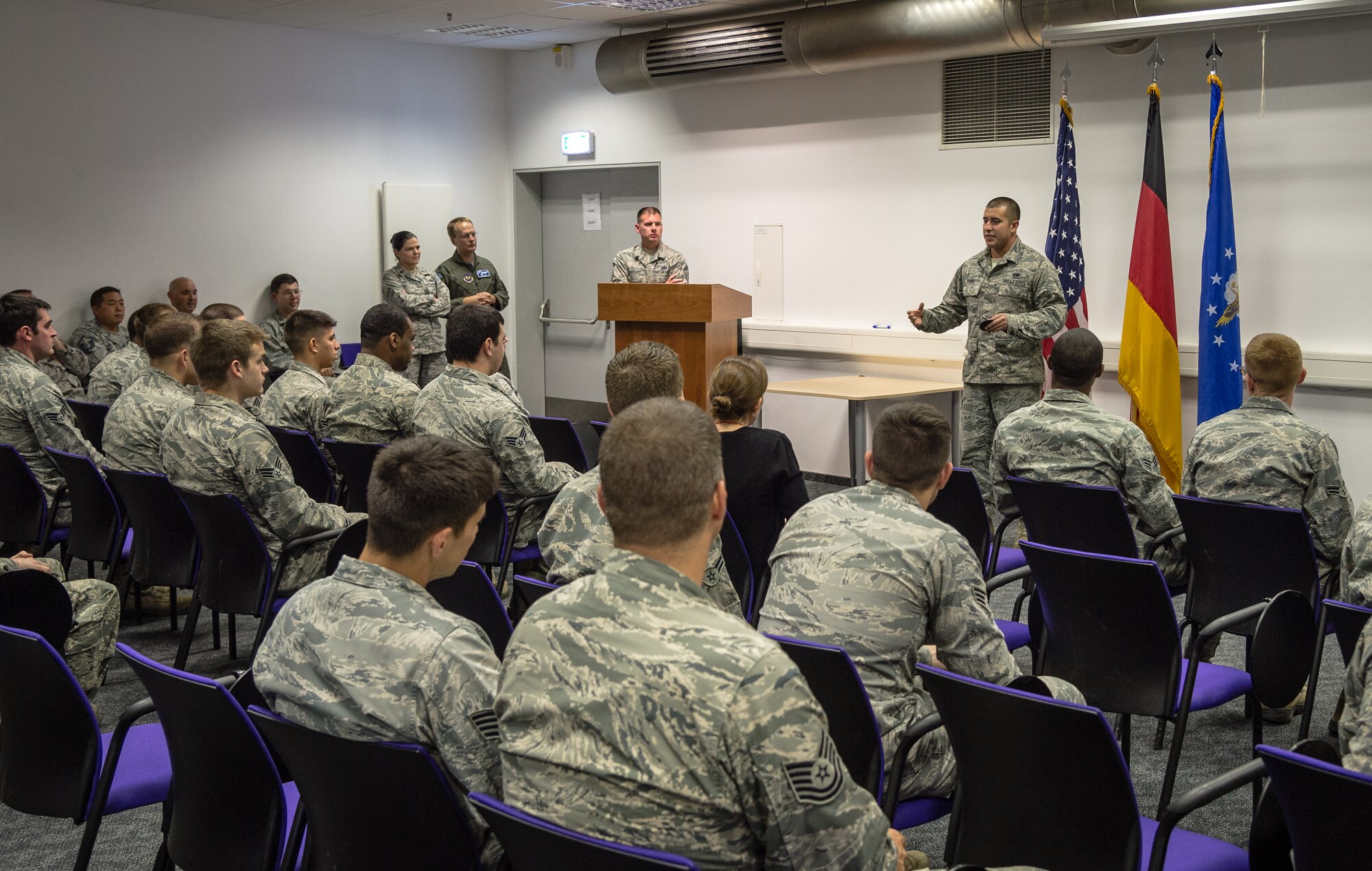 Airman 1st Class Christopher Torres, 86th Aircraft Maintenance Squadron dedicated crew chief, delivers a speech to shopmates after releasing a C-130J Super Hercules with a black letter designation on Ramstein Air Base, Germany, Oct. 7, 2014. A black letter designation indicates that an aircraft is operating under ideal circumstances and has no outstanding mechanical issues or due inspections. (U.S. Air Force photo/Airman 1st Class Jordan Castelan)