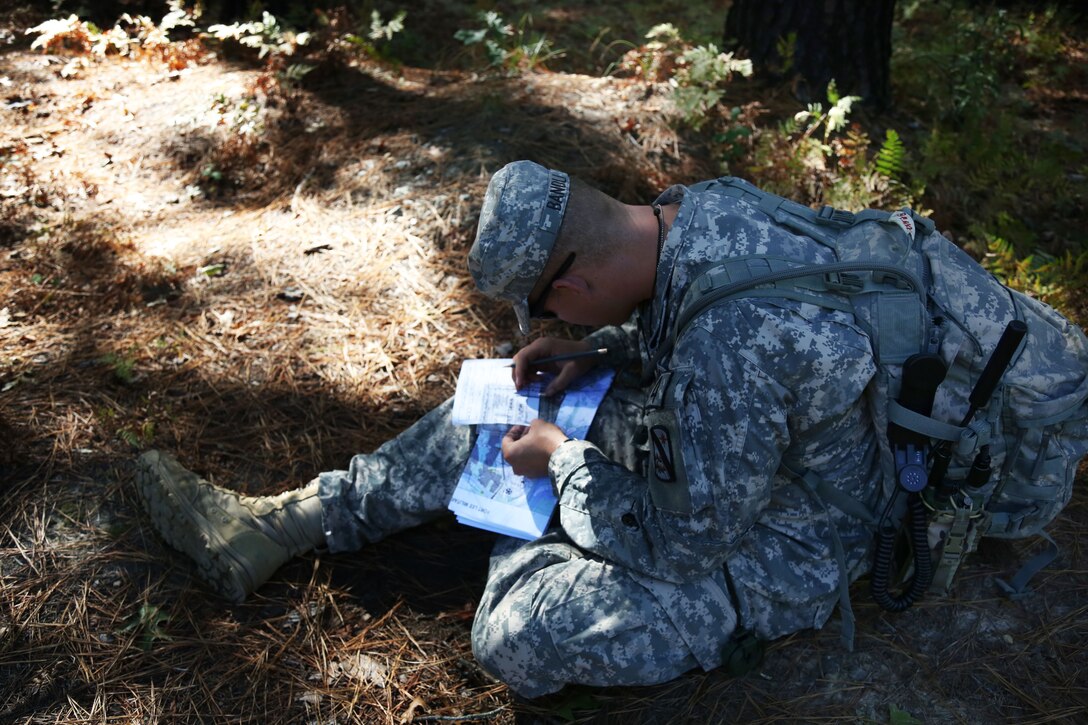 Army Cpl. Zachary Bandli plots his points for the land navigation course during the Best Warrior Competition on Fort Lee, Va., Oct. 8, 2014. Bandli is assigned to the U.S. Army Forces Command.