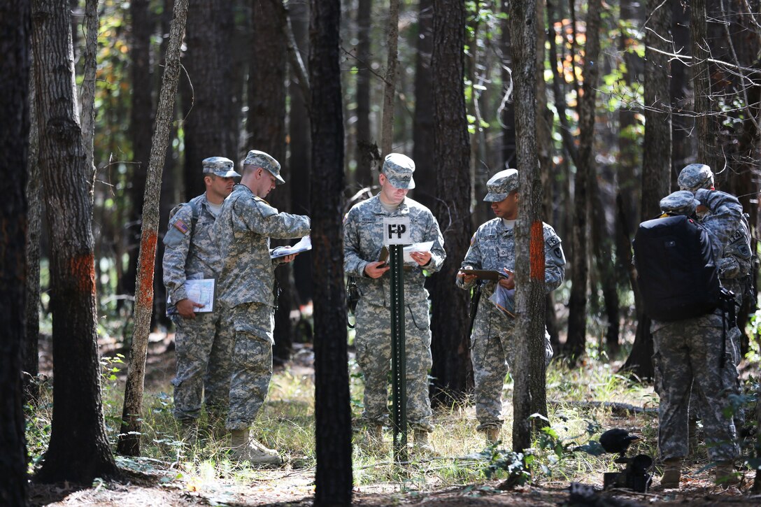 Soldiers plot their points for the land navigation course during the