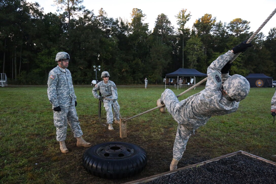 Army Sgt. Andres Martinez, right, navigates an obstacle course during the Best Warrior Competition on Fort Lee, Va., Oct. 9, 2014. Martinez is assigned to the U.S Army Installation Management Command.