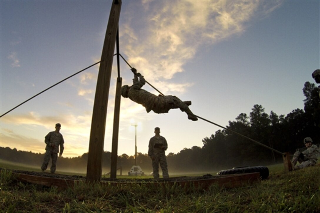 Army Spc. Ryan Montgomery, center, navigates an obstacle course while competing in the Department of the Army Best Warrior Competition at Fort Lee, Va., Oct. 8, 2014. Montgomery represented the Army National Guard as its top enlisted soldier of the year. 