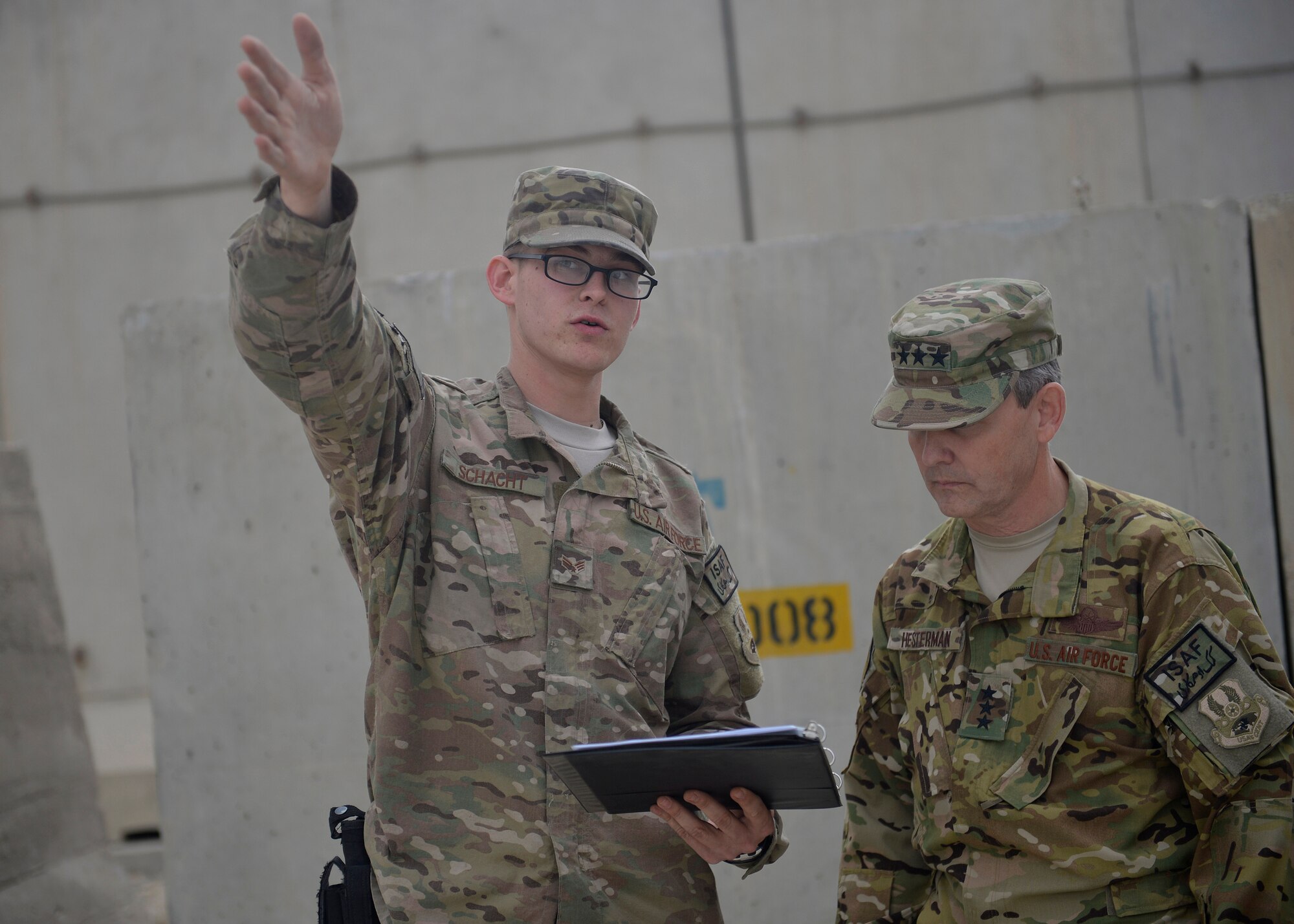 U.S. Air Force Senior Airman Corey Schacht, 455th Expeditionary Communications Squadron client systems journeyman, briefs Lt. Gen. John Hesterman, U.S. Air Forces Central Command commander, about how the unit supports the mission at Bagram Airfield, Afghanistan Oct. 7, 2014. Hesterman visited several units and thanked Airmen for their service.  (U.S. Air Force photo by Staff Sgt. Evelyn Chavez/Released)