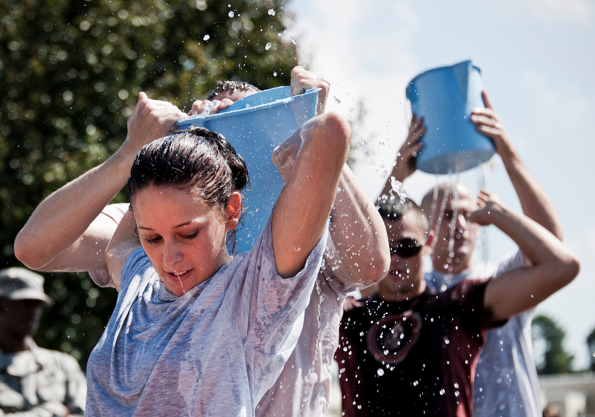 A 96th Security Forces Squadron team transfers a holy bucket of water from a pool to a large barrel during this year’s Fire Muster Challenge Oct. 10 at Eglin Air Force Base, Fla.  Teams competed in the challenge that included shooting and rolling up the fire hose, victim-carry and water relay. (U.S. Air Force photo/Samuel King Jr.)