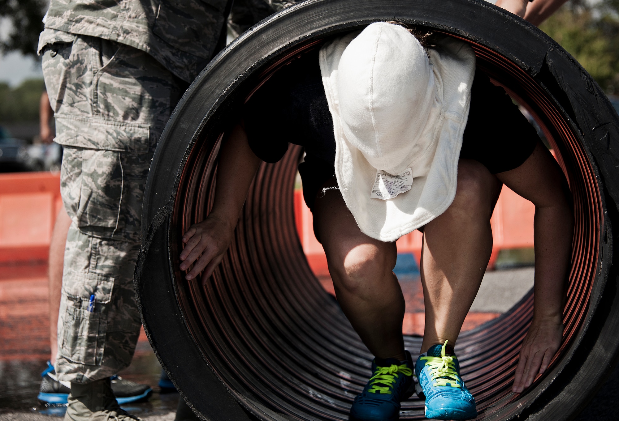 An Airman with the First Sergeants team moved through a tube while blindfolded during this year’s Fire Muster Challenge Oct. 10 at Eglin Air Force Base, Fla.  Teams competed in the challenge that included shooting and rolling up the fire hose, victim-carry and water relay. (U.S. Air Force photo/Samuel King Jr.)