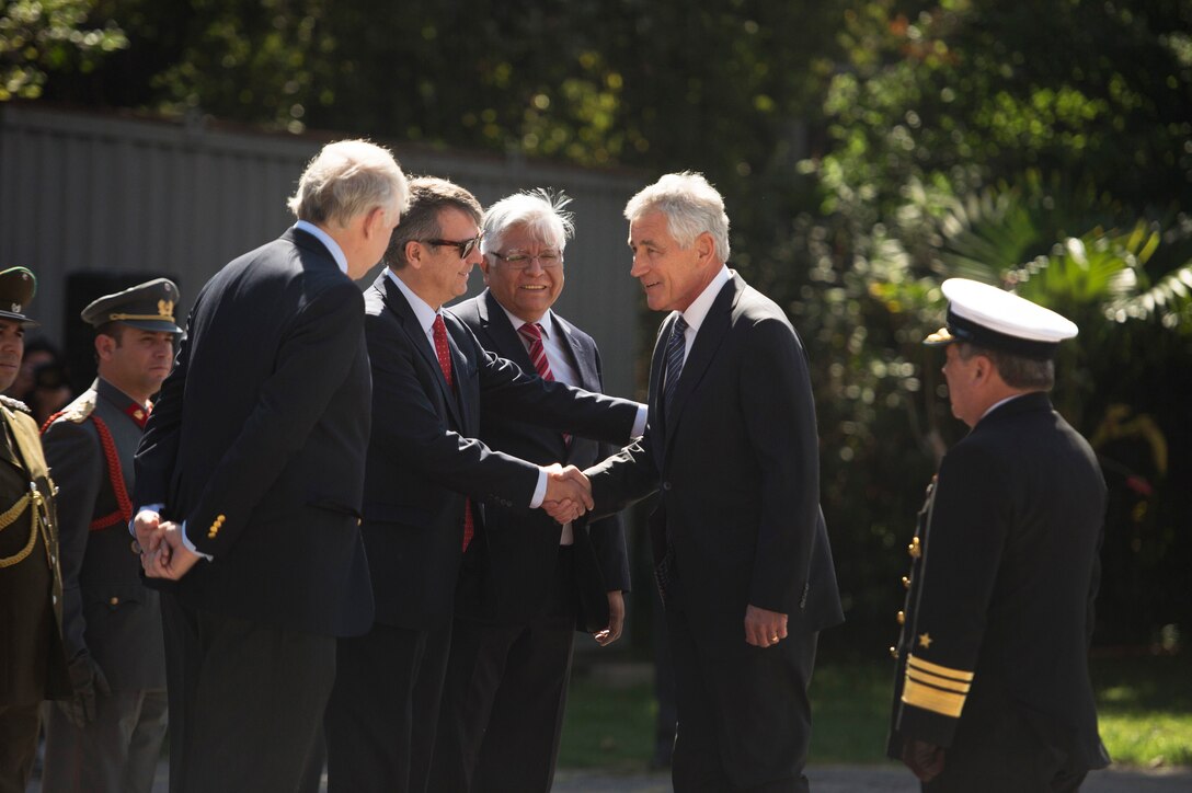 U.S. Defense Secretary Chuck Hagel, second from right, shakes hands with Marcos Robledo, Chilean undersecretary of defense, as he arrives to meet with the Chilean Defense Minister Jorge Burgos at the Defense Ministry in Santiago, Chile, Oct. 11, 2014. 