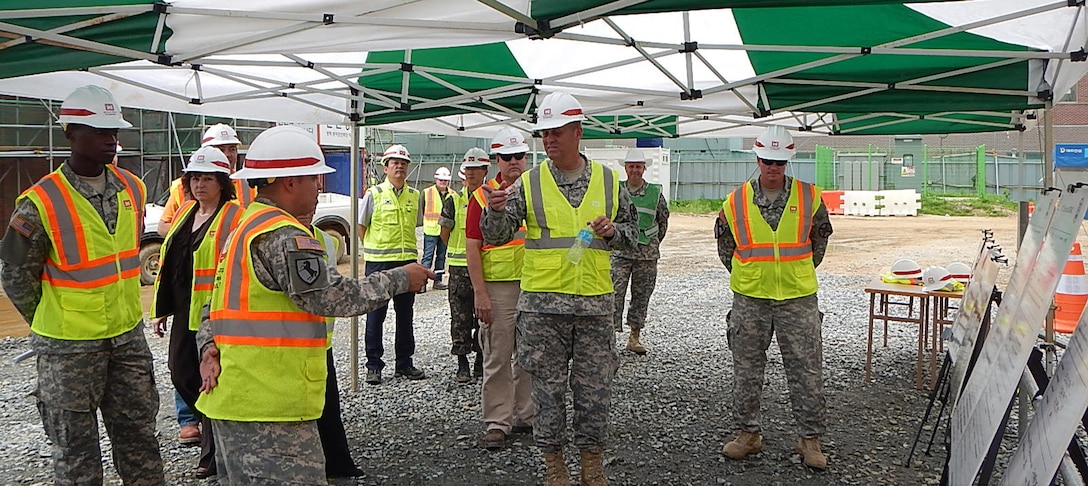 Capt. Joseph Claros (foreground), project engineer at the Pyeongtaek resident office and ADOS Soldier gives a briefing to Lt. Gen. David D. Halverson, Commander, U.S. Army Installation Management Command and Assistant Chief of Staff for Installation Management. 