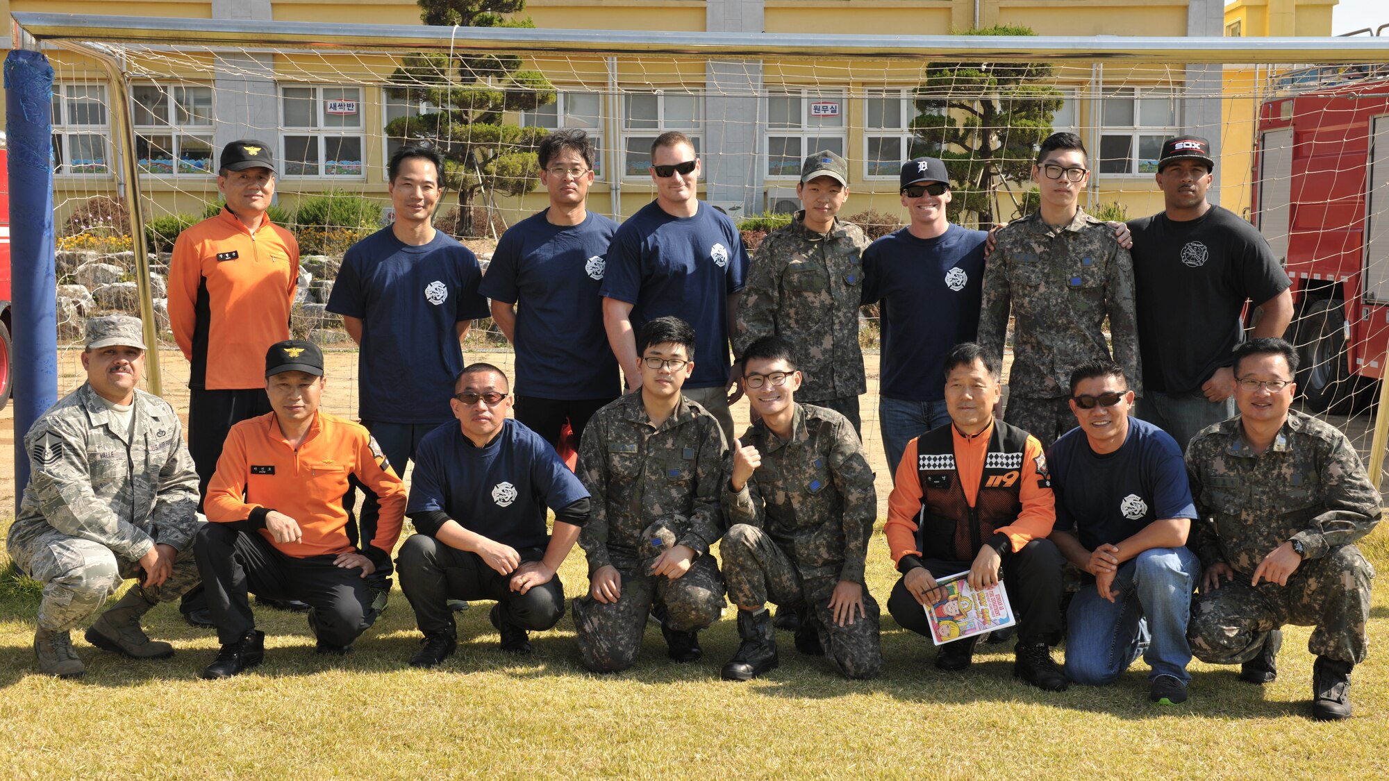 Fire department members from the 8th Civil Engineer Squadron, Republic of Korea air force 38th Fighter Group, and local Gunsan City Fire Department pose for a photo following a fire prevention demonstration at Okbong Elementary School, Oct. 7, 2014. As part of fire prevention week, Kunsan’s fire department conducted more than 10 fire drills and provided fire safety training Oct. 5-11. (U.S. Air Force photo by Senior Airman Katrina Heikkinen/released)